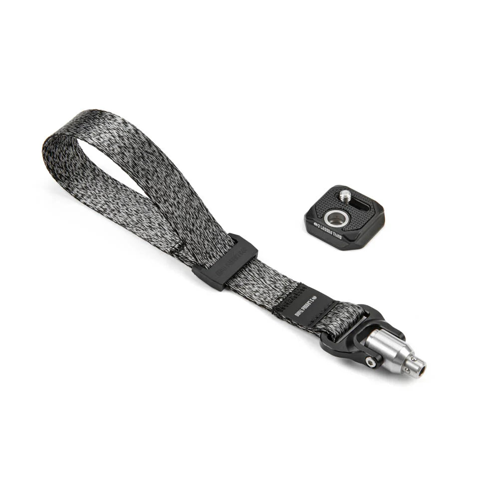 Camera strap with quick release clip on a white background