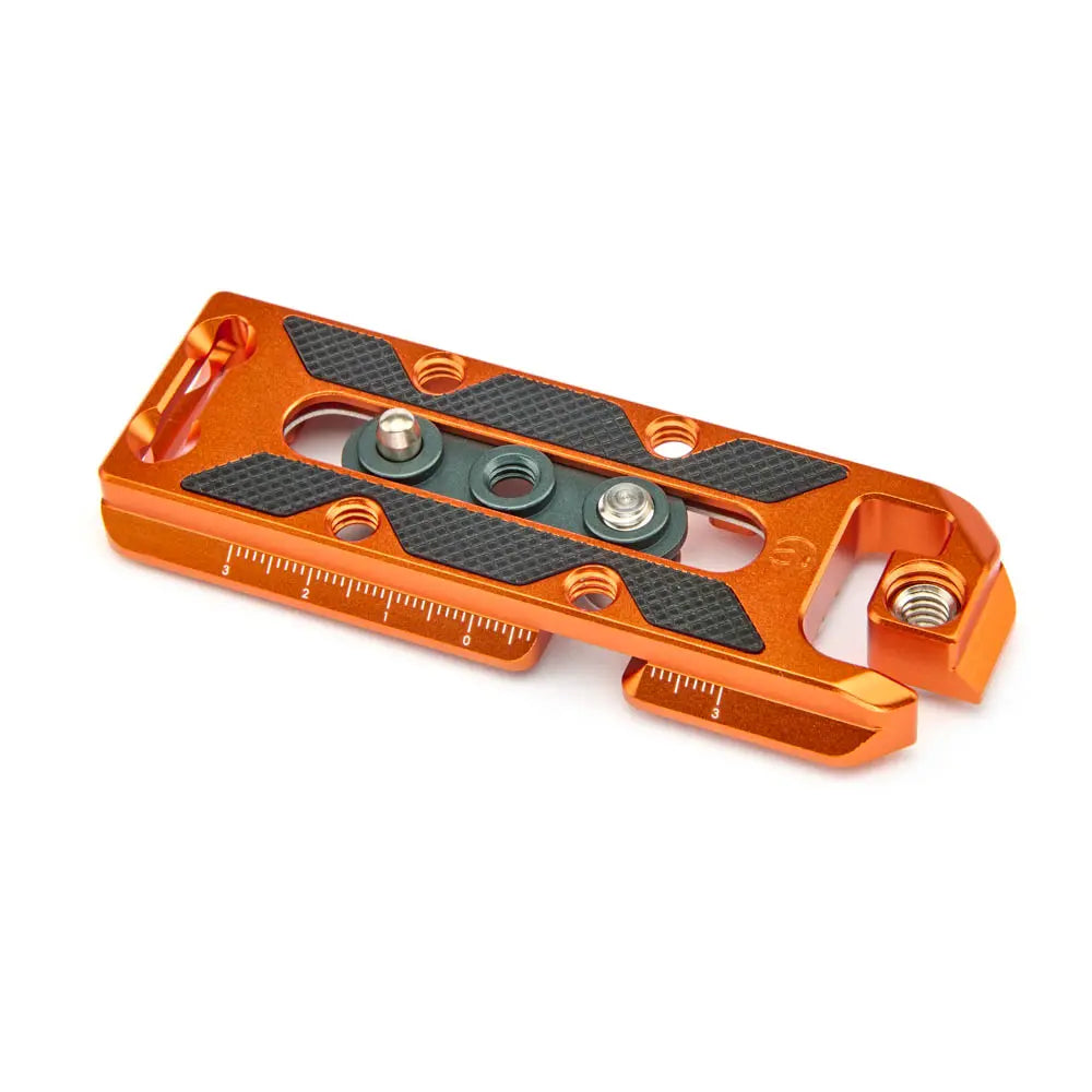 Orange metal tool with black textured surface on a white background