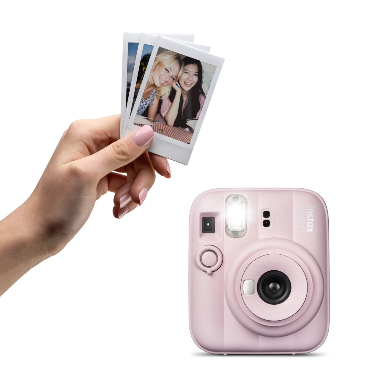 Pink instant camera with a hand holding three photos on a white background