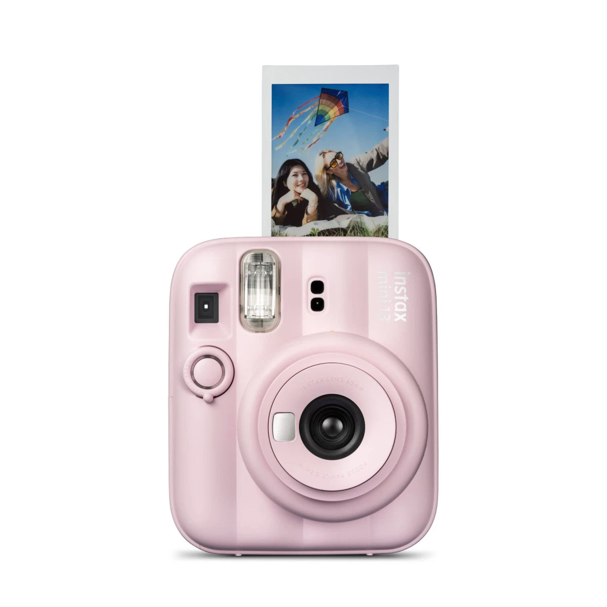 Pink instant camera with a photo of two people and a kite on the screen