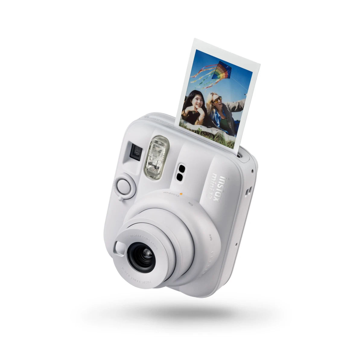 White instant camera with a photo on the display against a white background