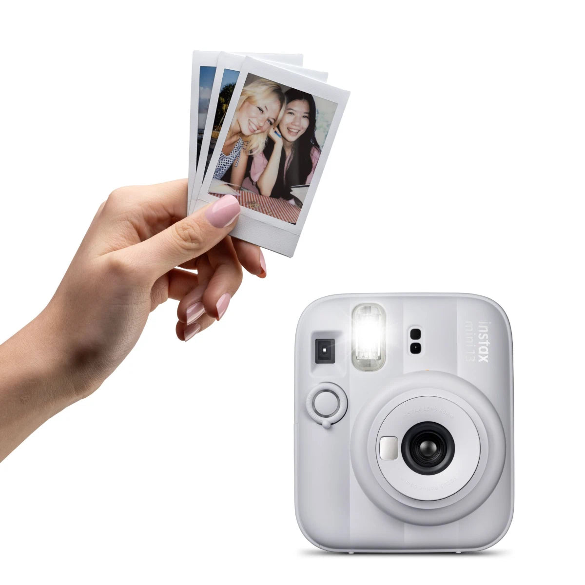 Instant camera with a hand holding instant photos on a white background