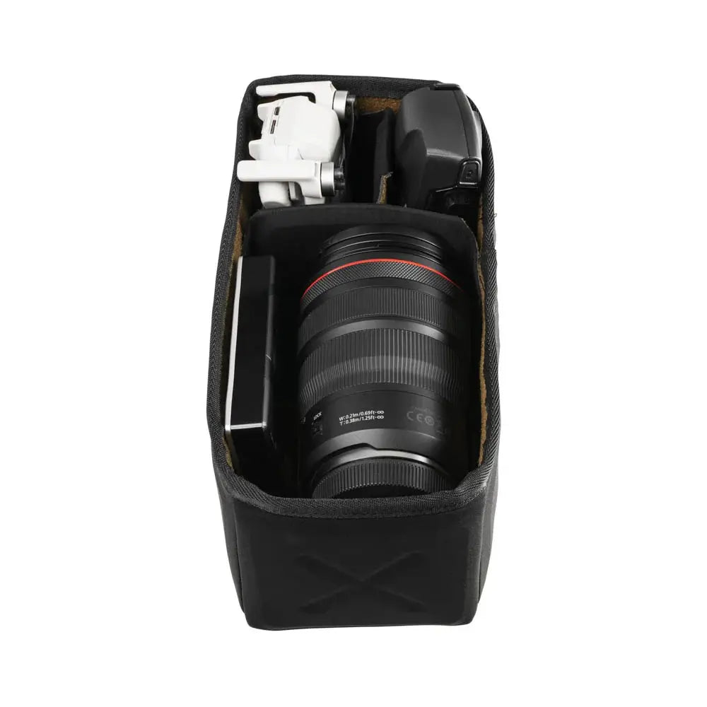 Camera lens and accessories in a black carrying case on a light gray background