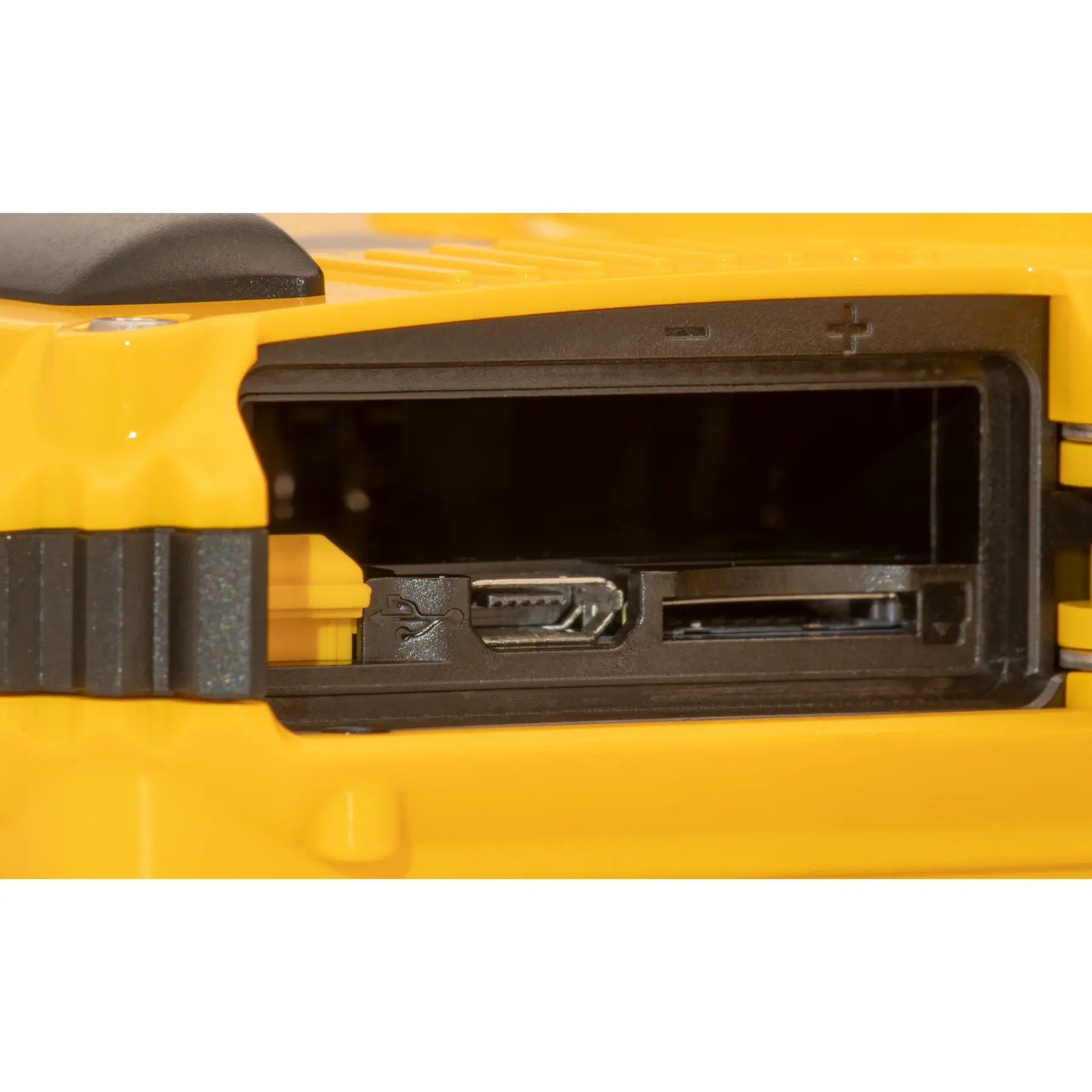 Close-up of a yellow tool with a black component on a white background