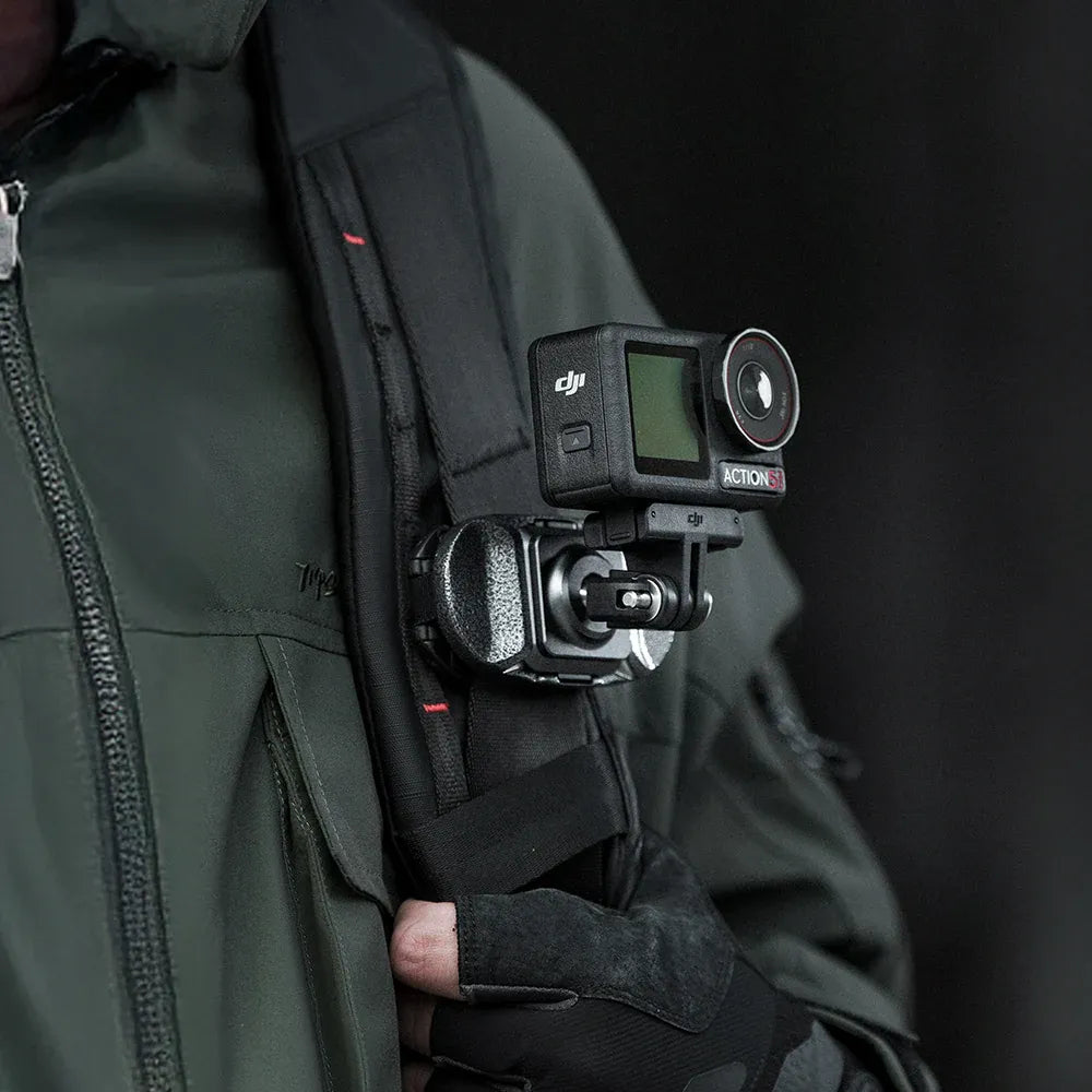Person wearing a green jacket with a DJI action camera attached to it.