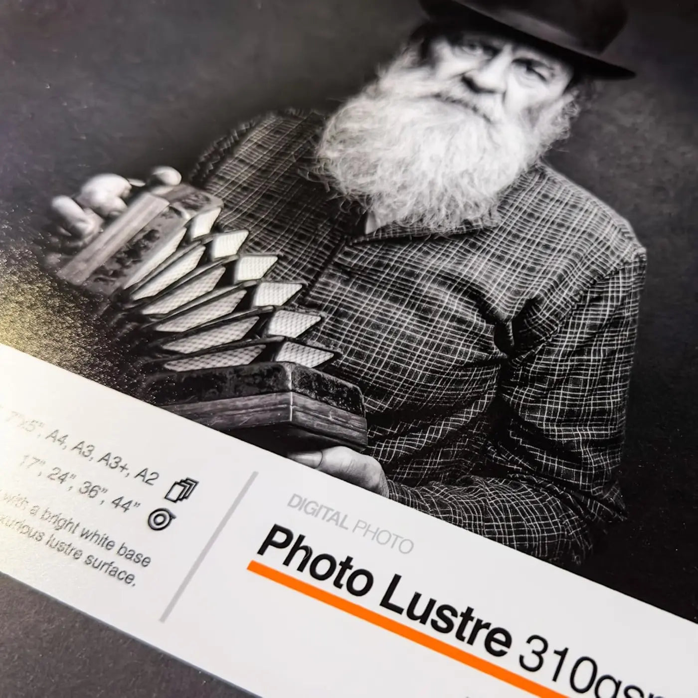 Man with a beard holding a deck of cards on a Photo Lustre 3100s packaging.