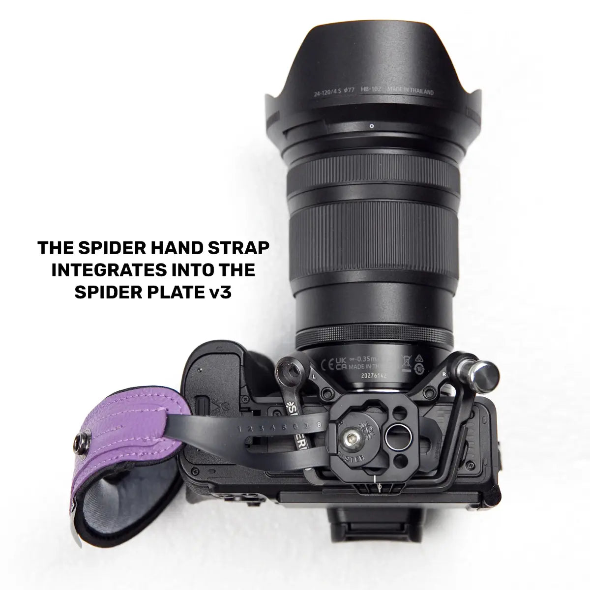 Camera with spider hand strap integration on a white background