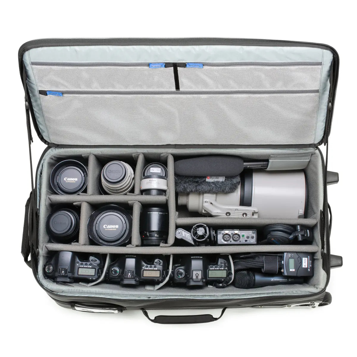 Camera equipment including lenses and a camera body inside an open suitcase with compartments.