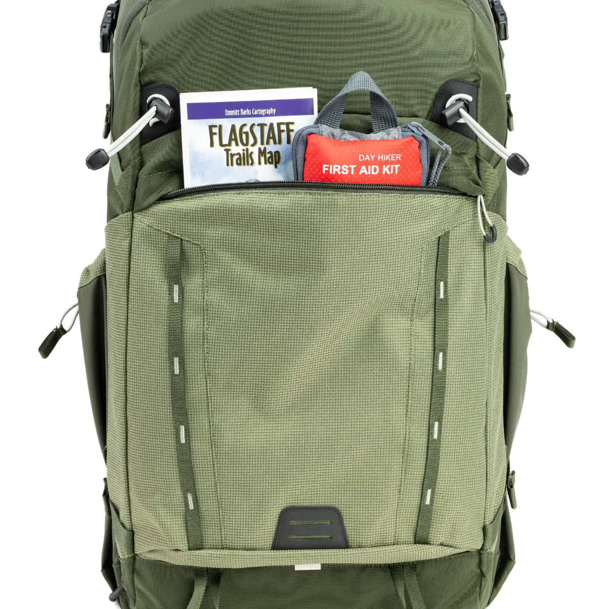 Green backpack with items like a map and first aid kit on a white background