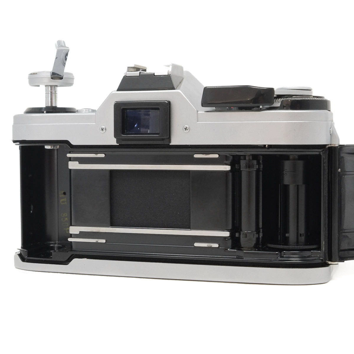Vintage camera with open film chamber on a white background