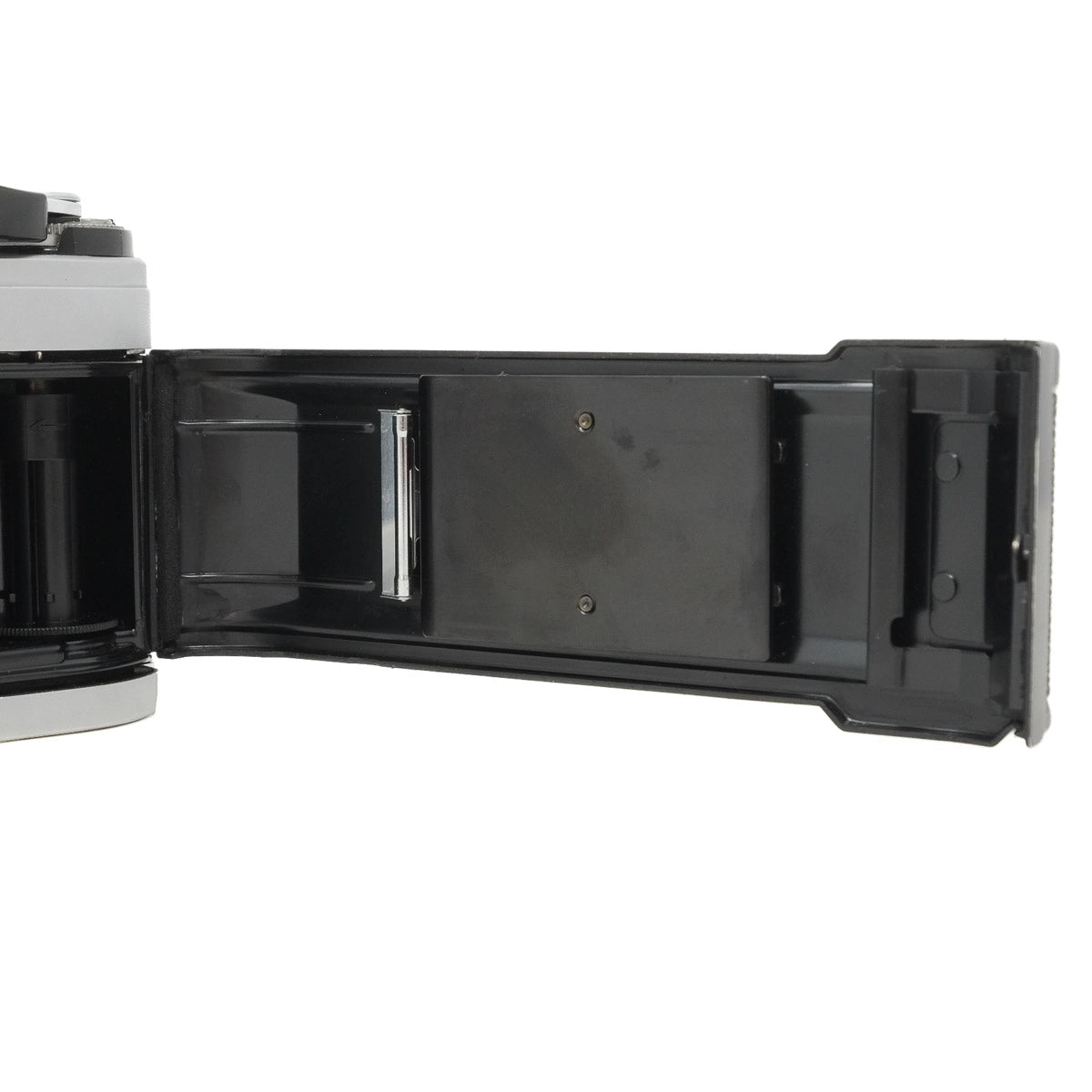 Open camera body with film back on a white background