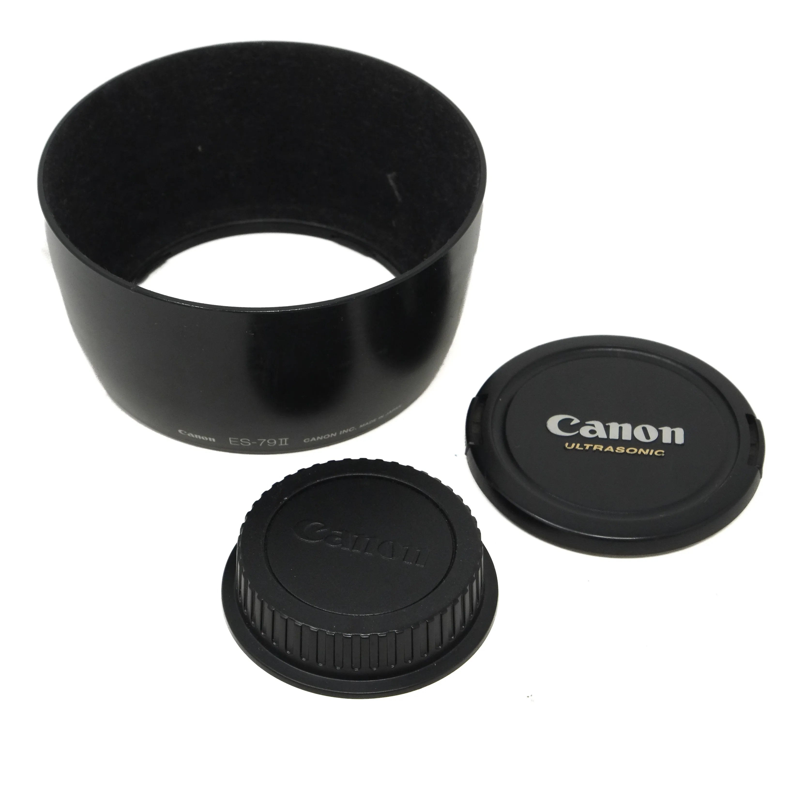 Canon lens hood and caps on a white background