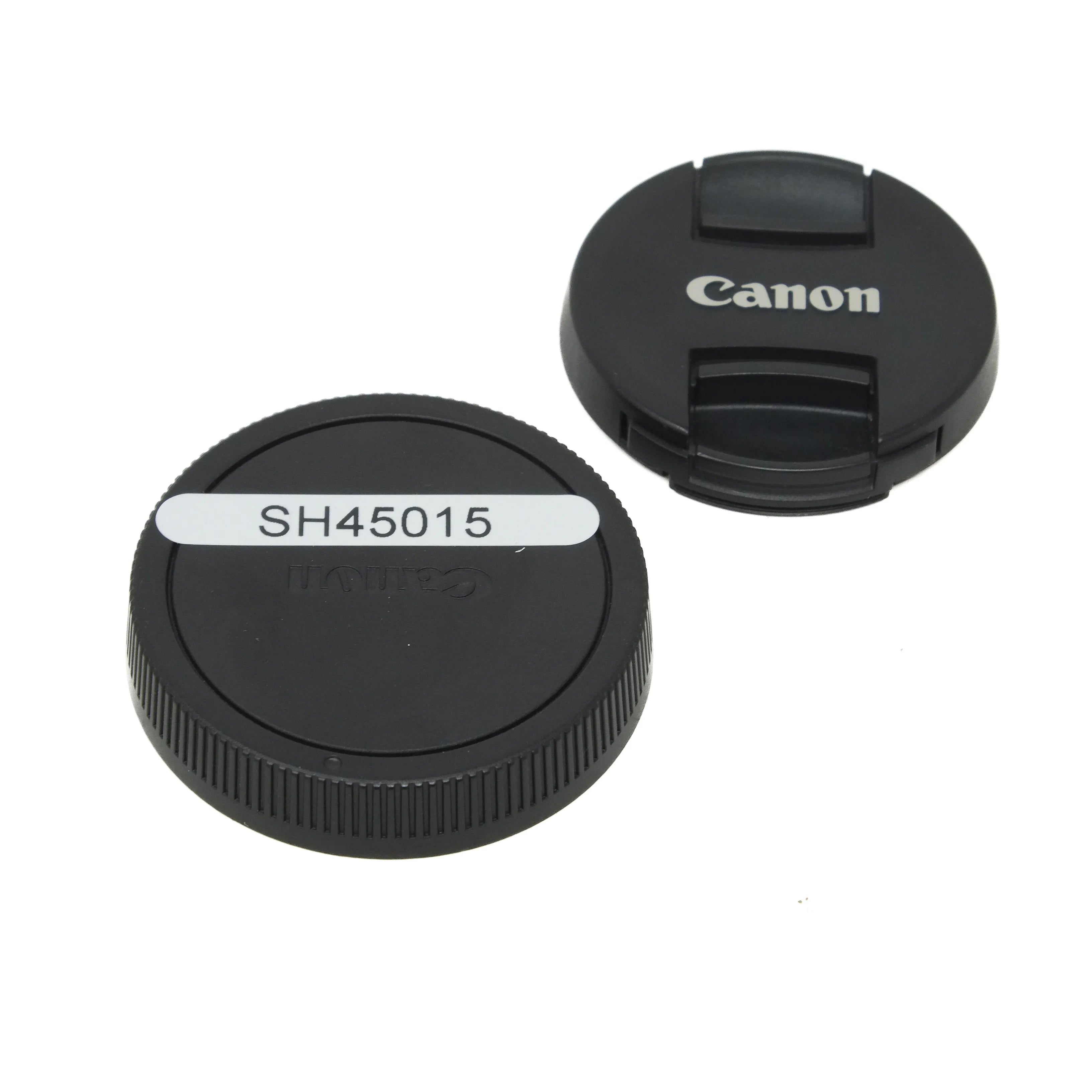 Two black camera lens caps with 'Canon' branding on a white background