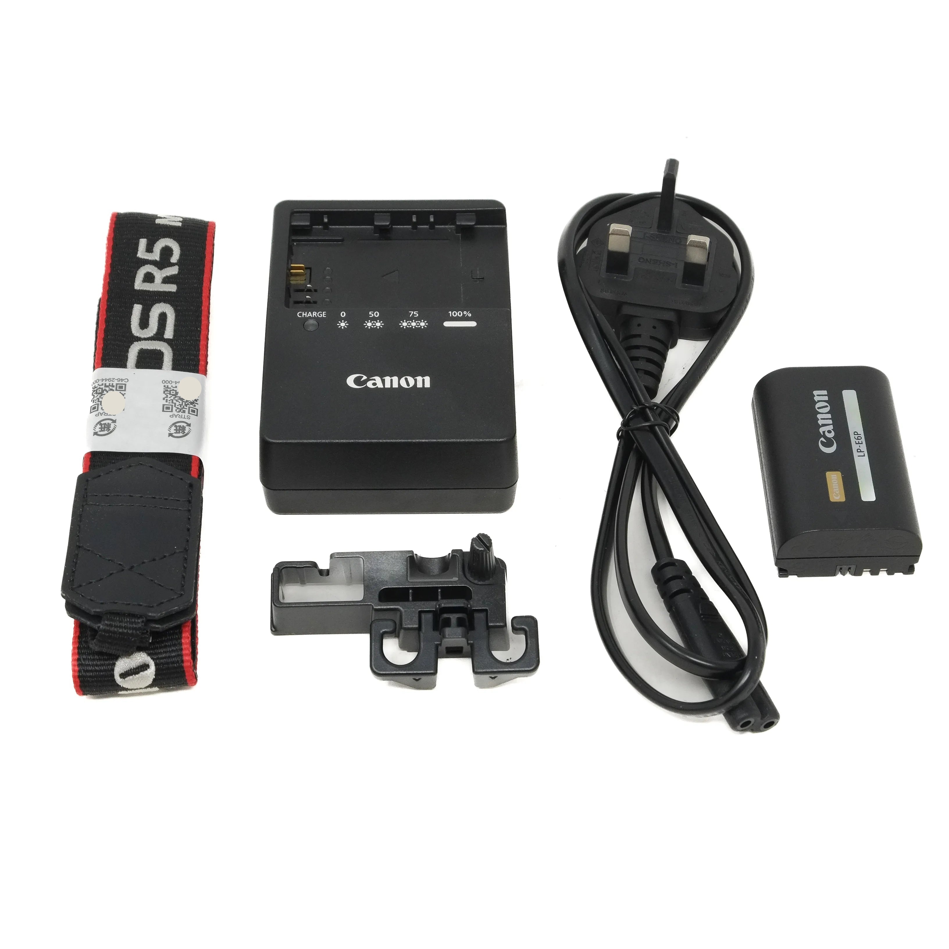 Canon camera battery, charger, and accessories on a white background