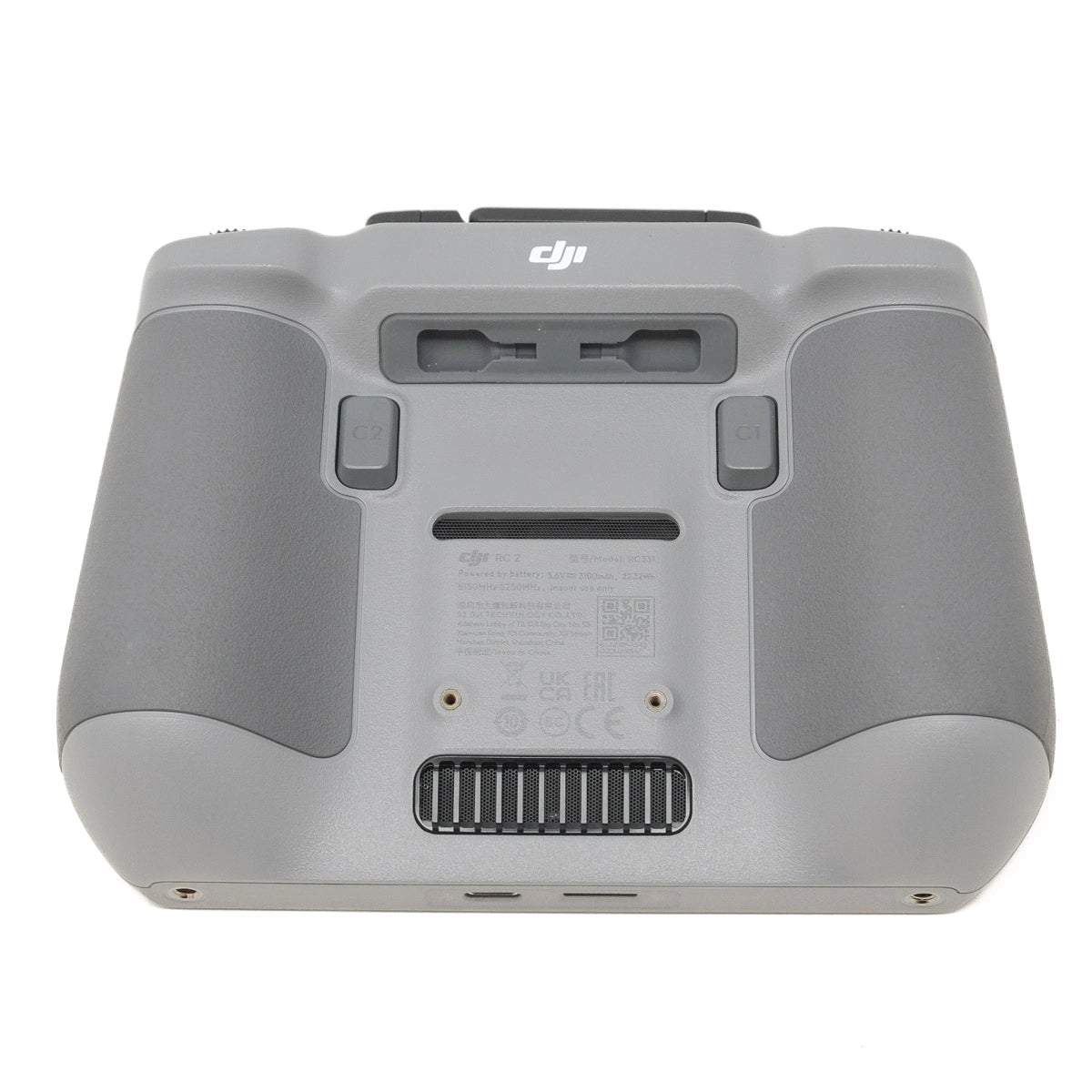 Back view of a gray controller with DJI logo on a white background