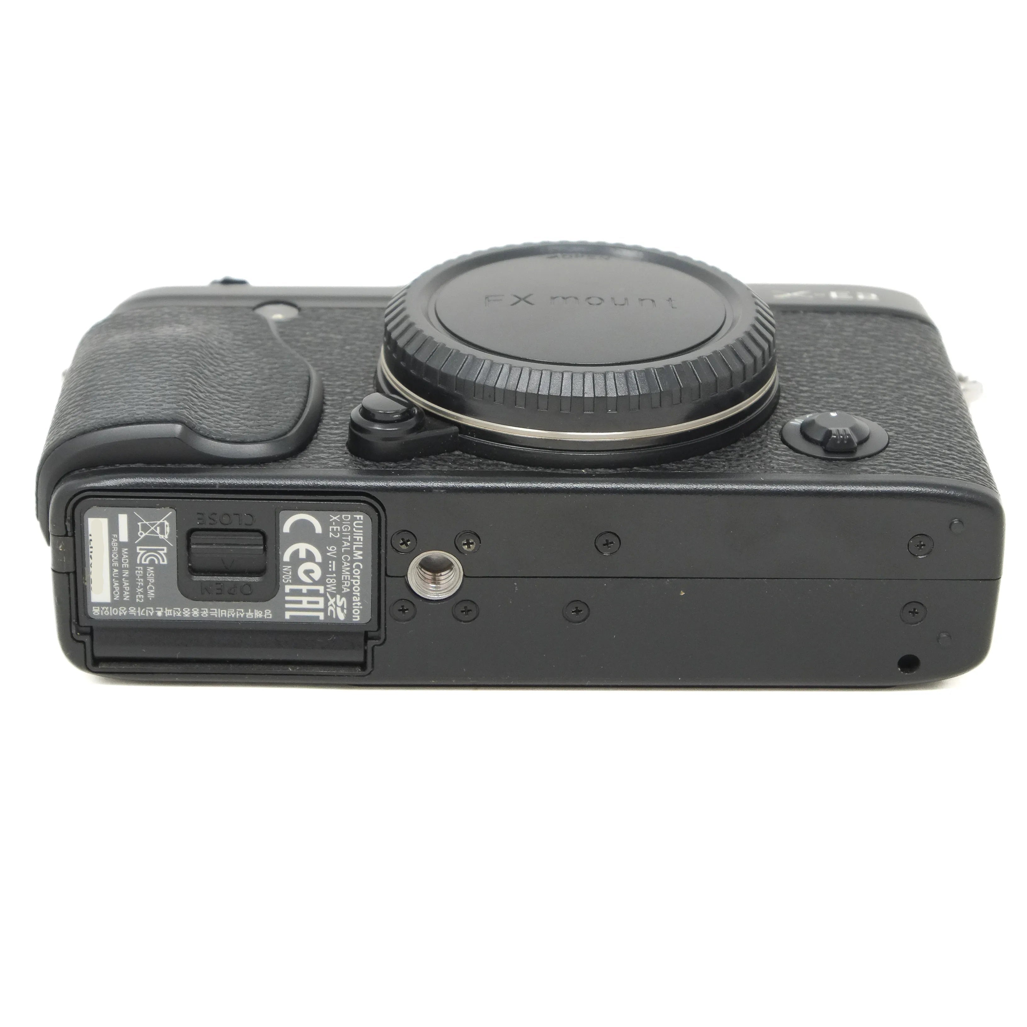 Black camera body with body cap on a white background