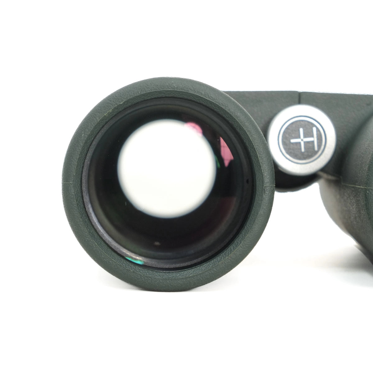 Close-up of a green binoculars lens on a white background