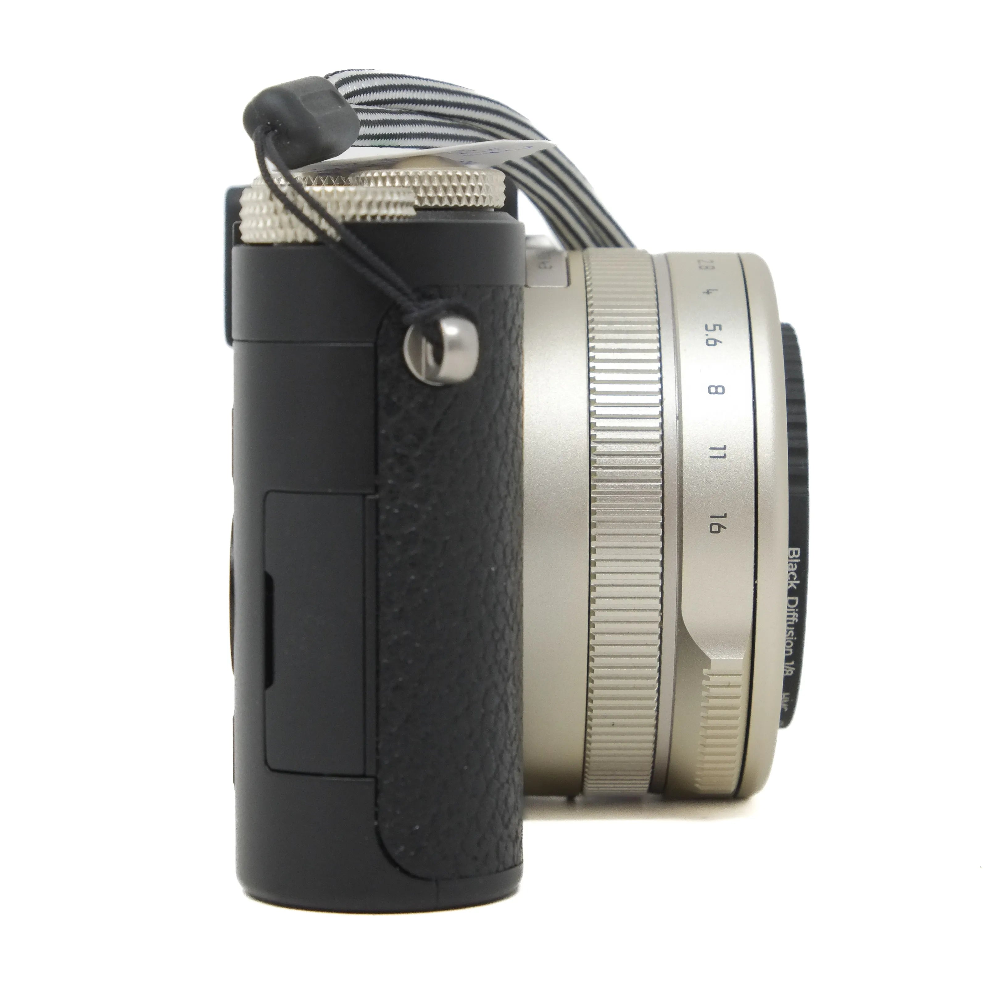 Camera with black grip and silver lens on a white background