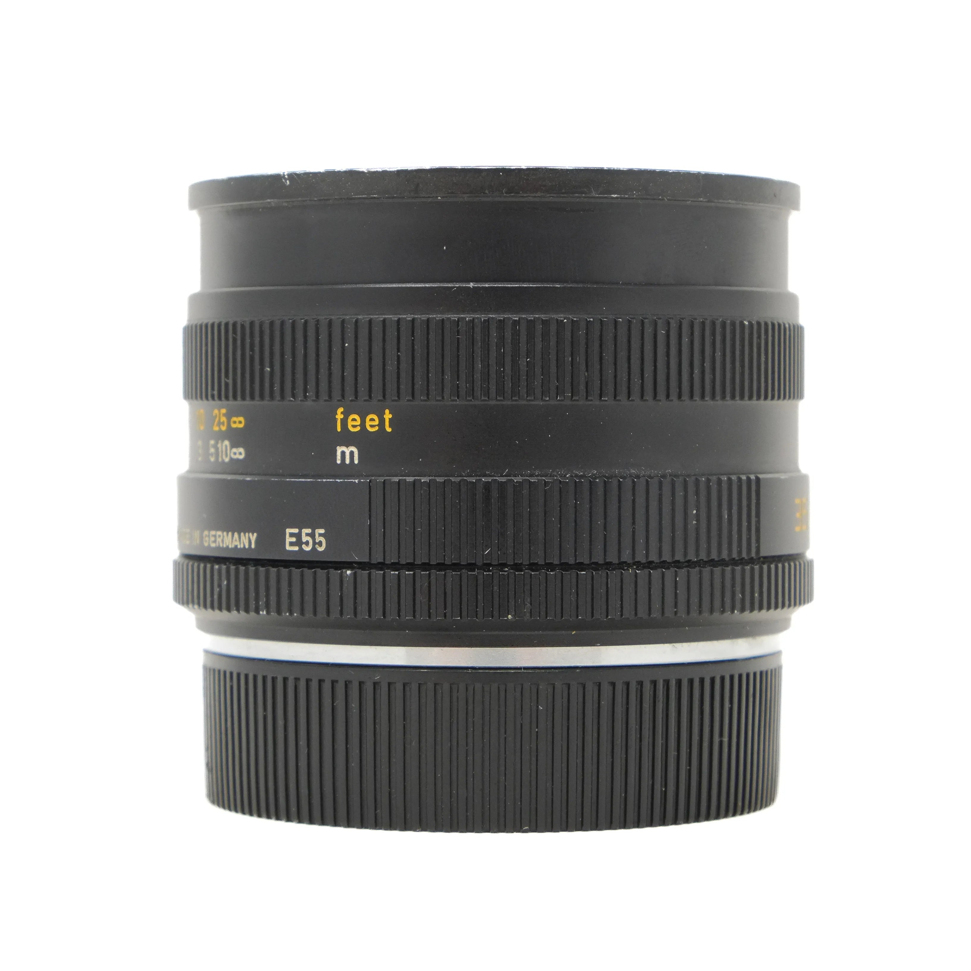 Black camera lens with measurement markings on a white background