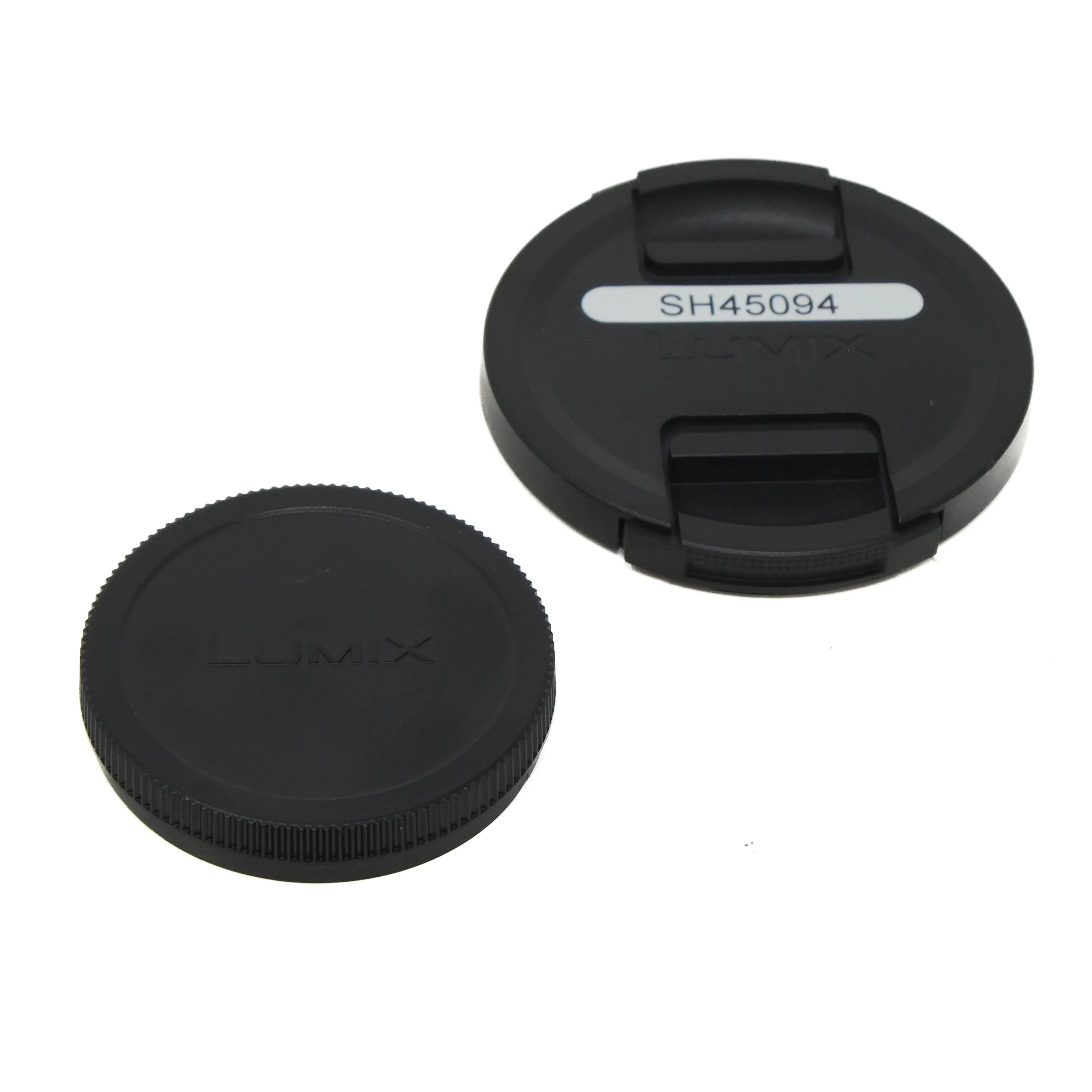 Two black camera lens caps on a white background, one with 'LUMIX' branding and the other with a model number.