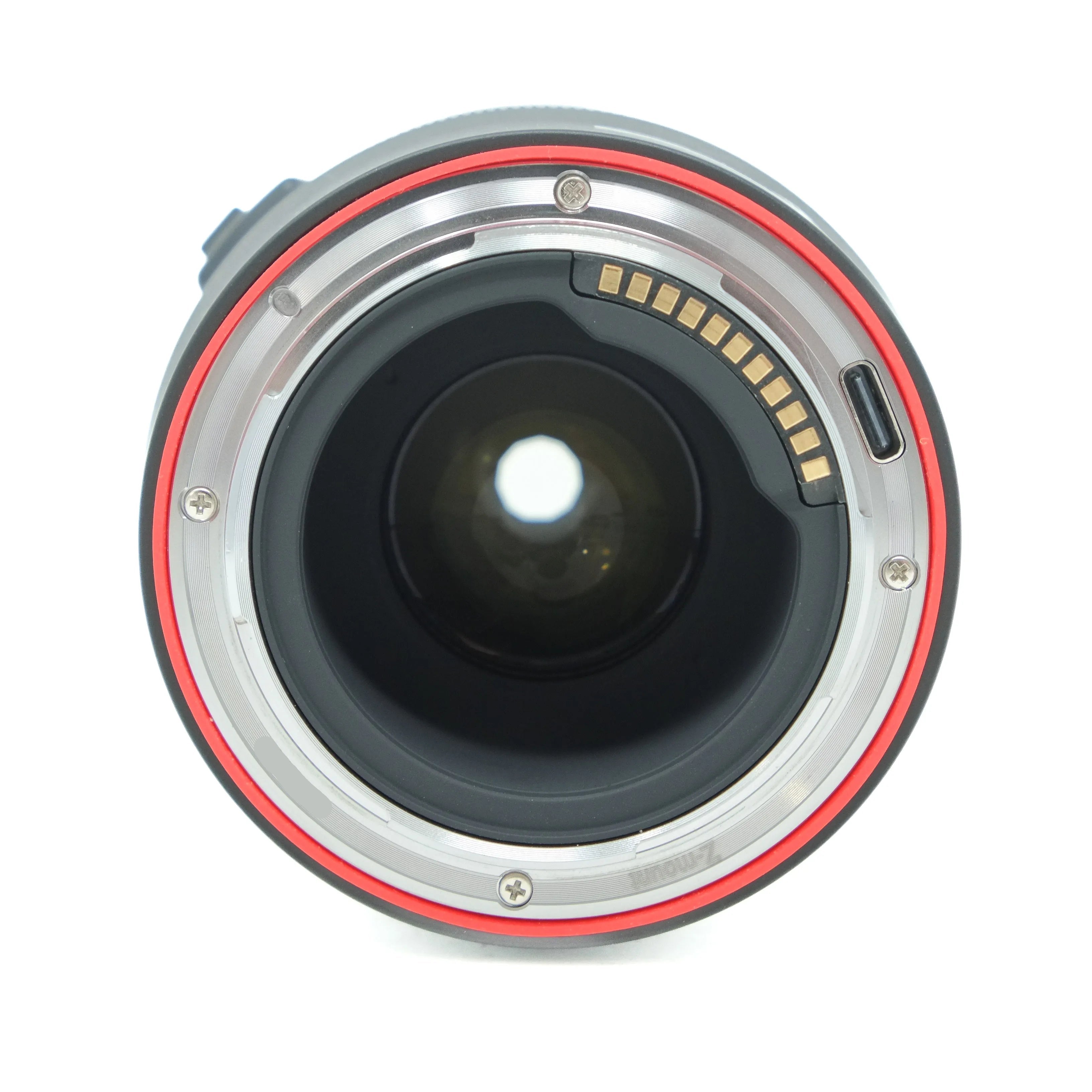 Camera lens with red and silver accents on a white background
