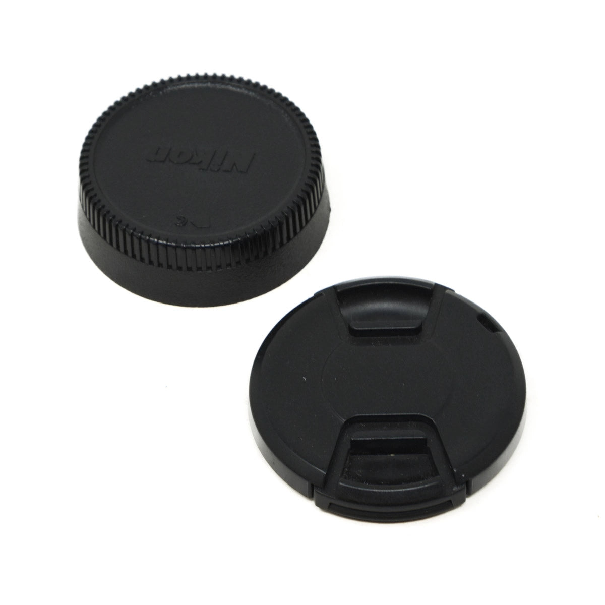 Two black camera lens caps on a white background, one with 'Nikon' branding.