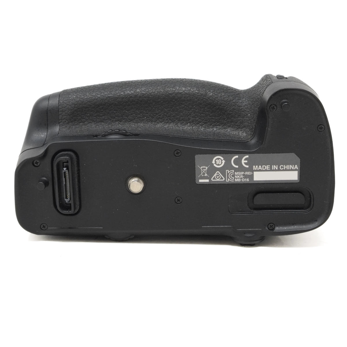 Black camera battery grip with label on a white background