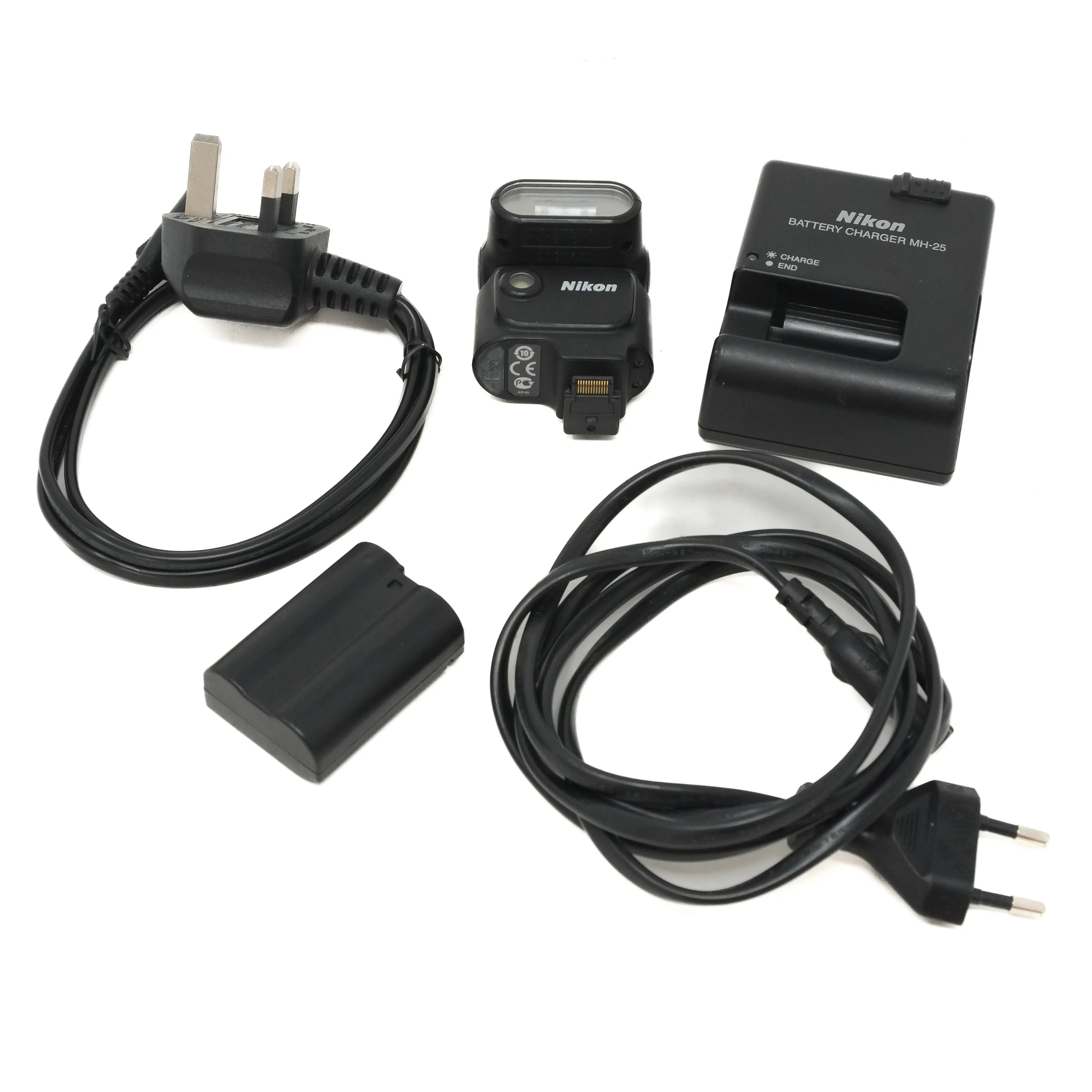 Nikon camera battery, charger, and cables on a white background