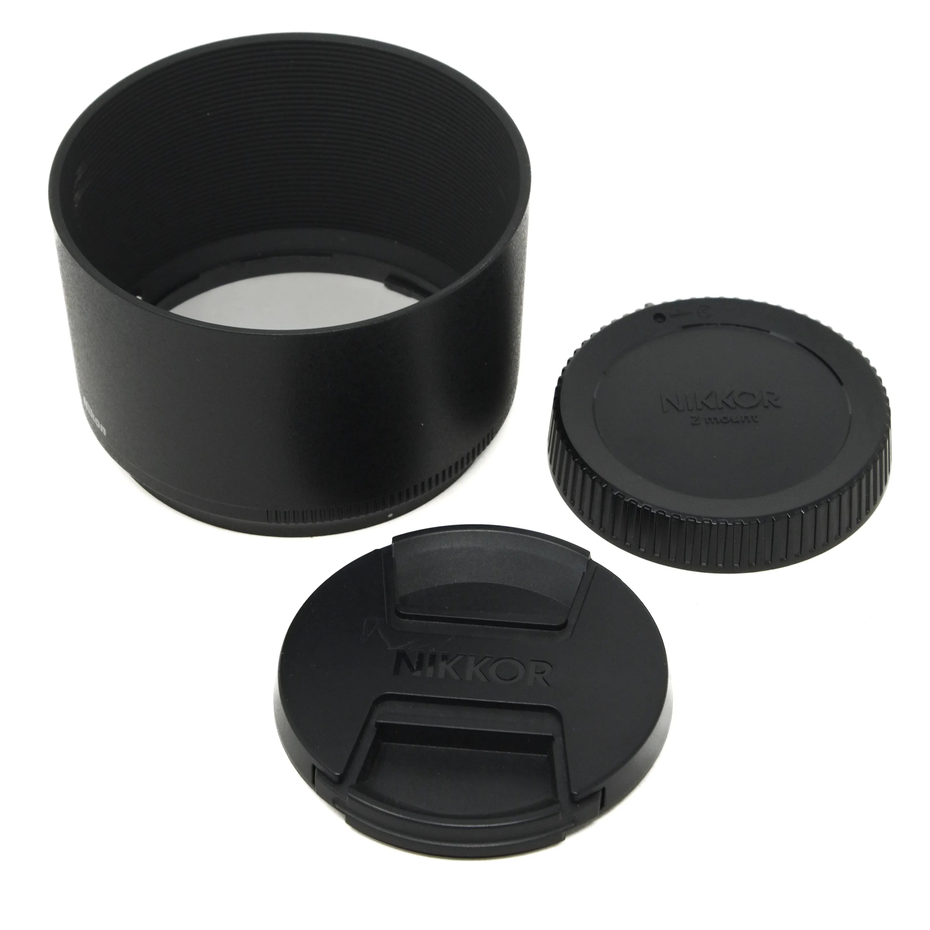 Black camera lens hood and front and rear covers on a white background