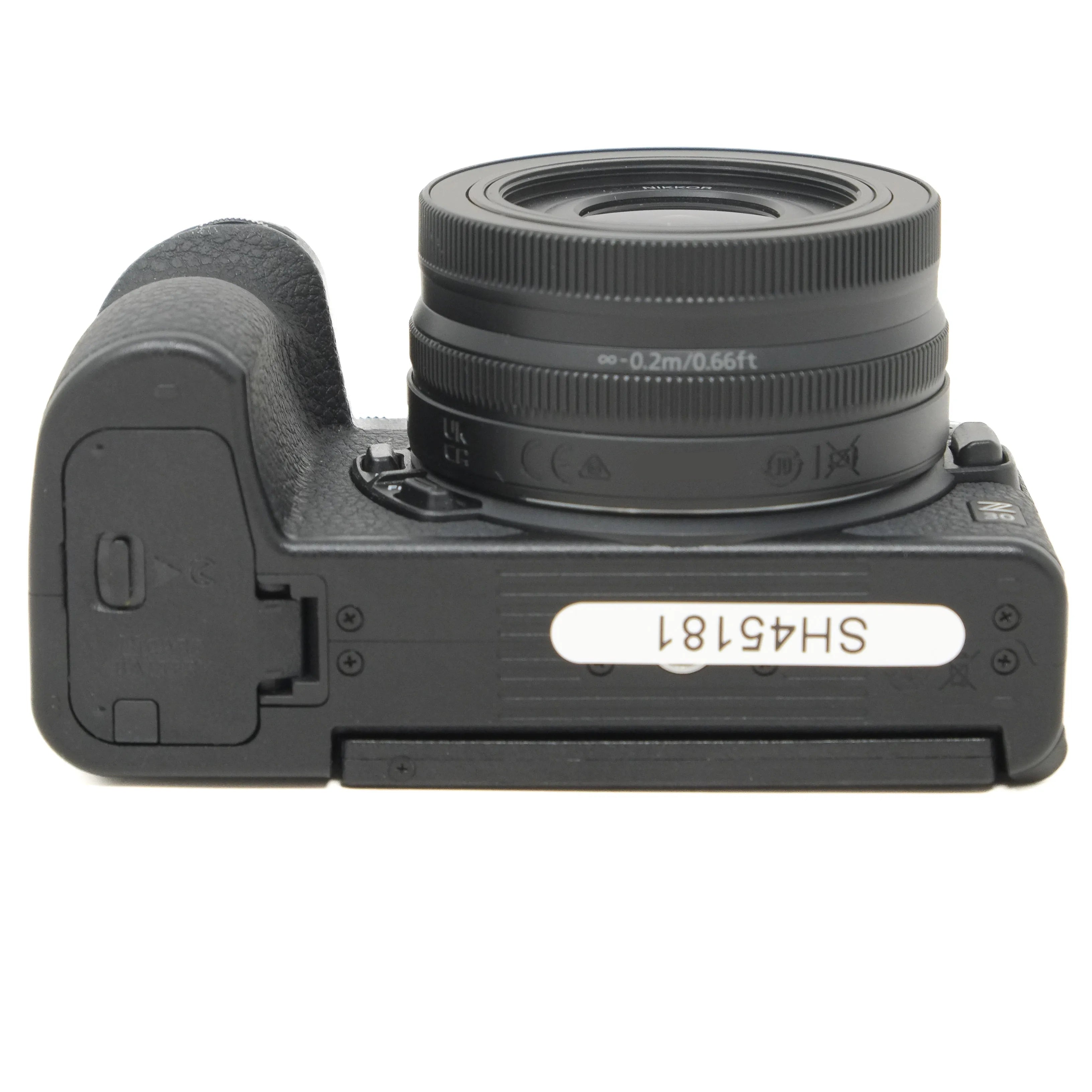Black camera with lens on a white background