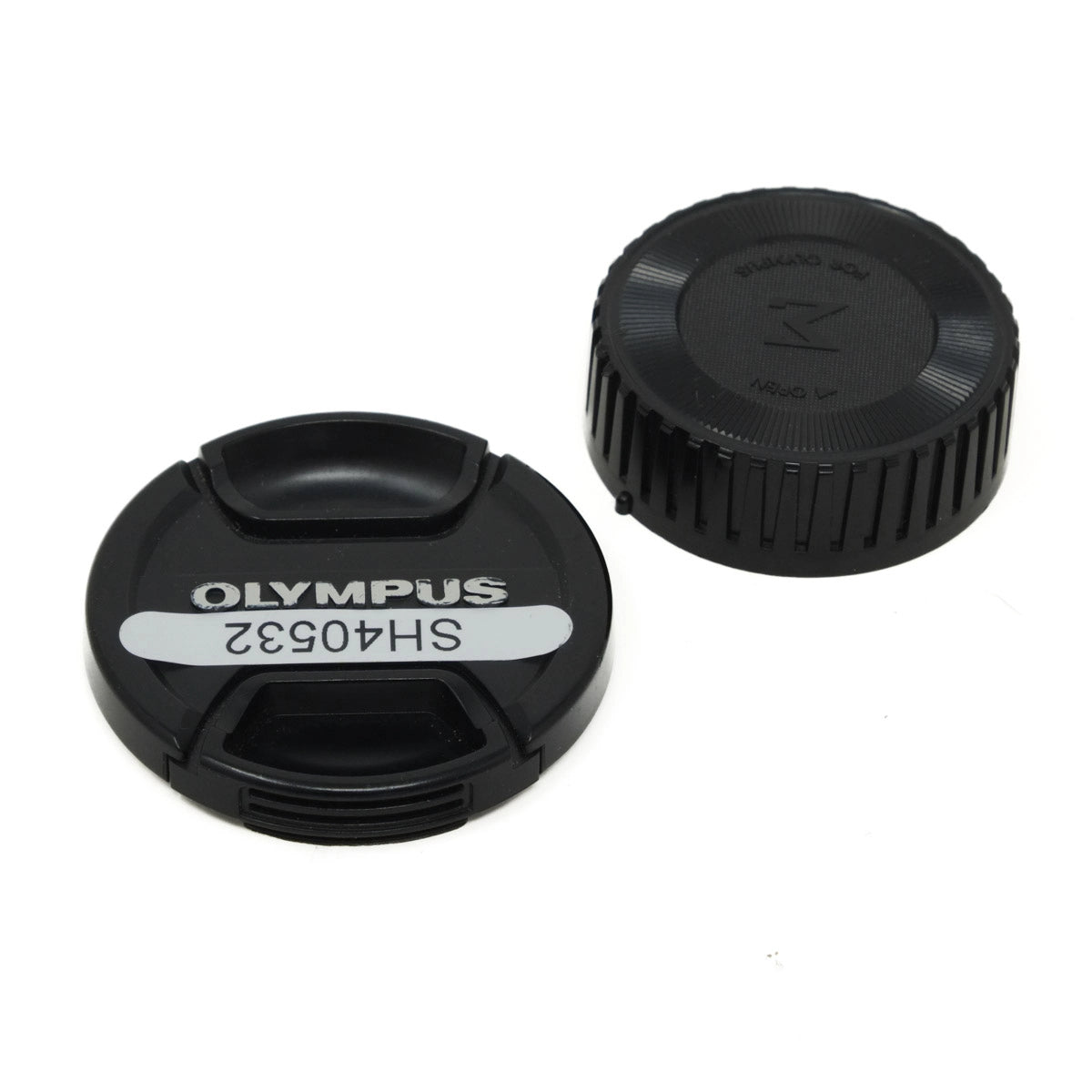 Two black camera lens caps with 'Olympus' branding on a white background