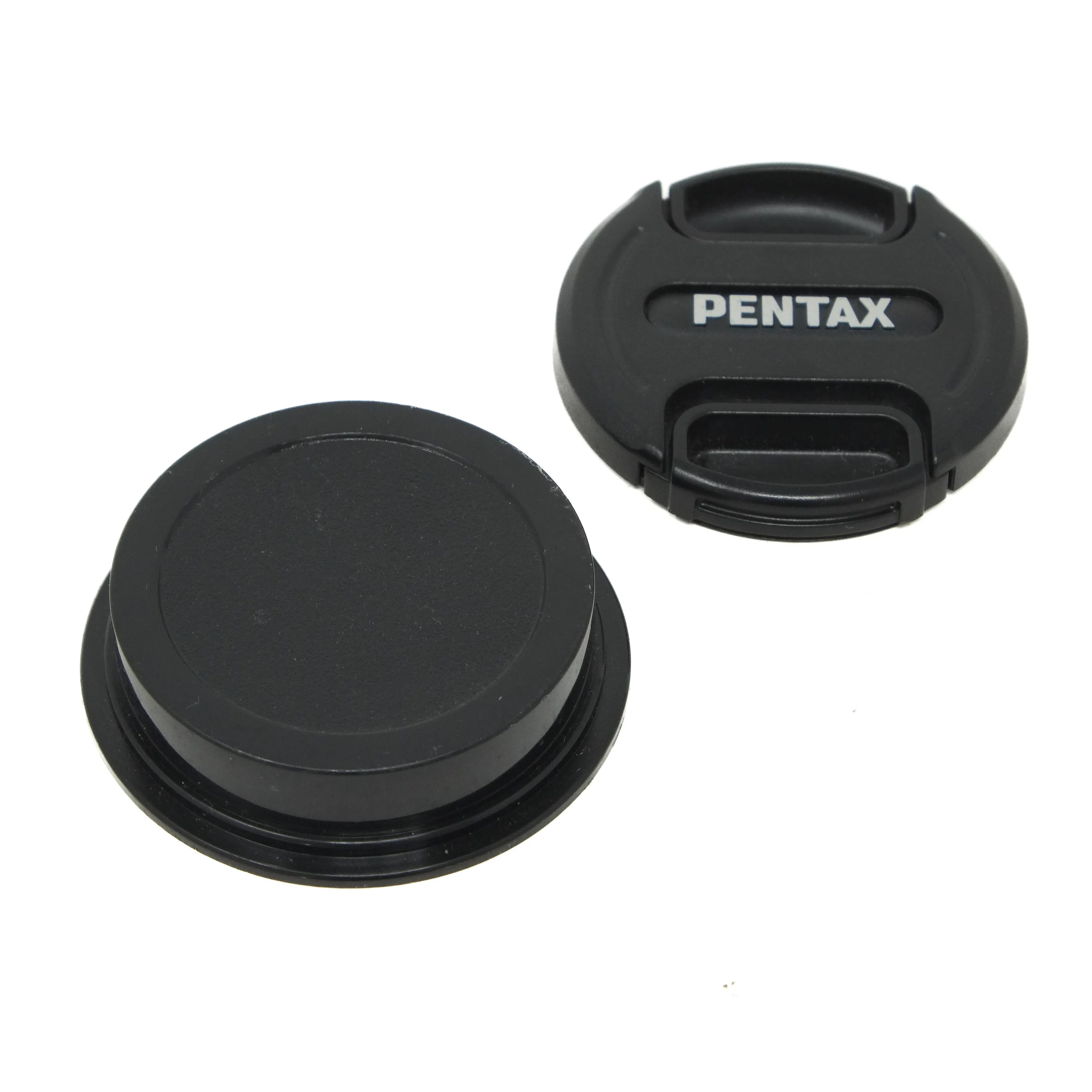 Two black camera lens caps with 'Pentax' branding on a white background
