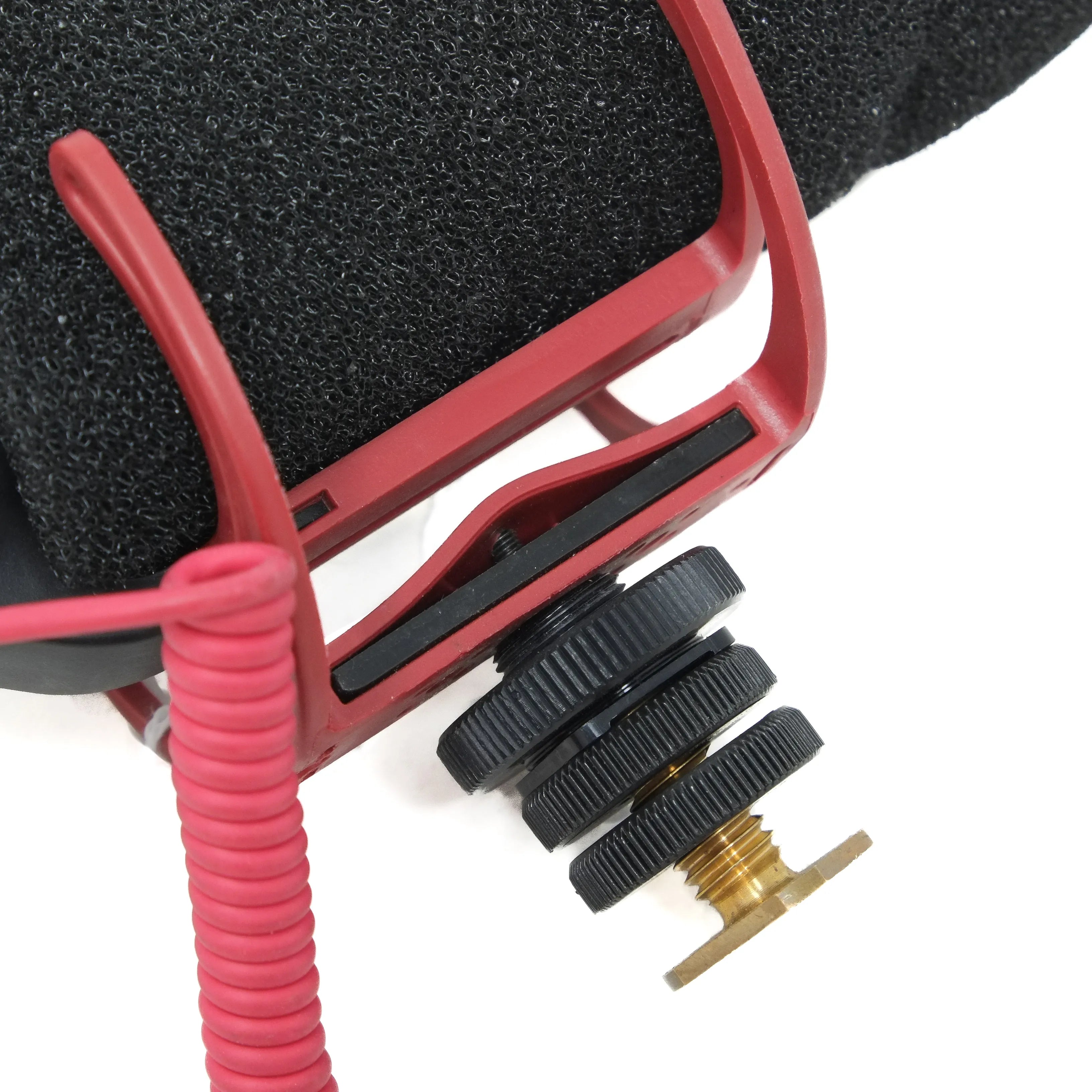Close-up of a microphone with a red foam cover on on a white background