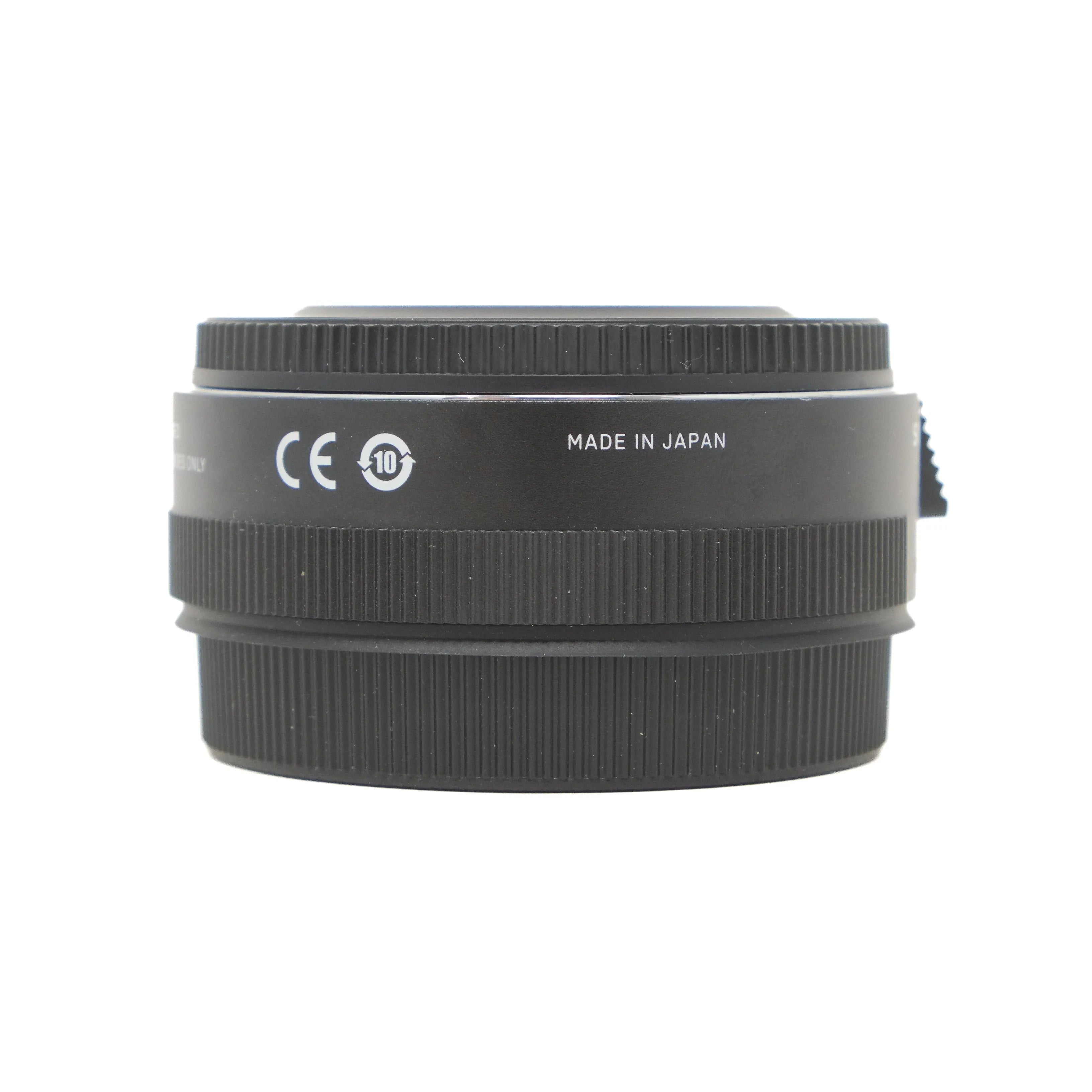 Black camera lens teleconverter with 'Made in Japan' text on a white background