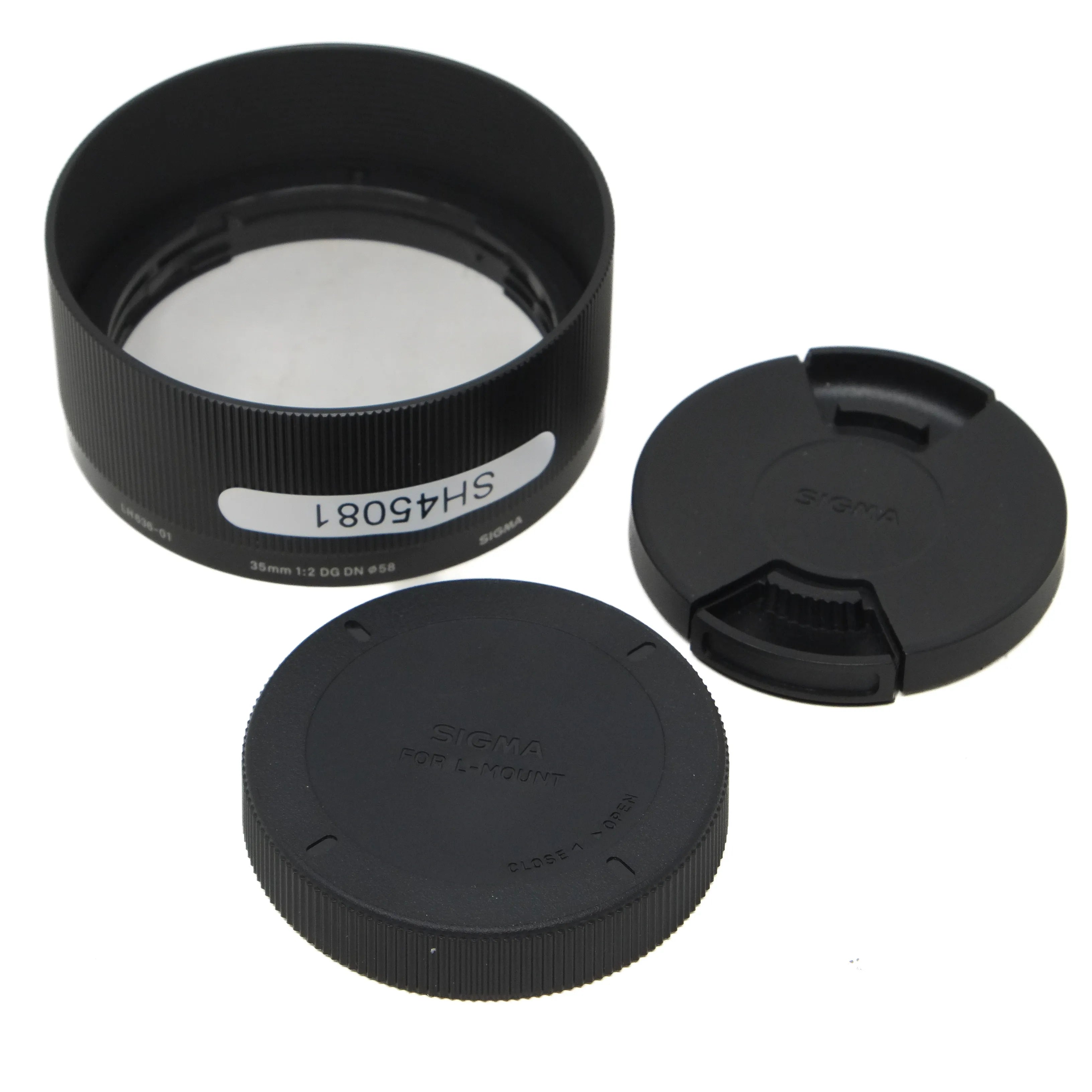 Camera lens hood, front cap, and rear cap on a white background