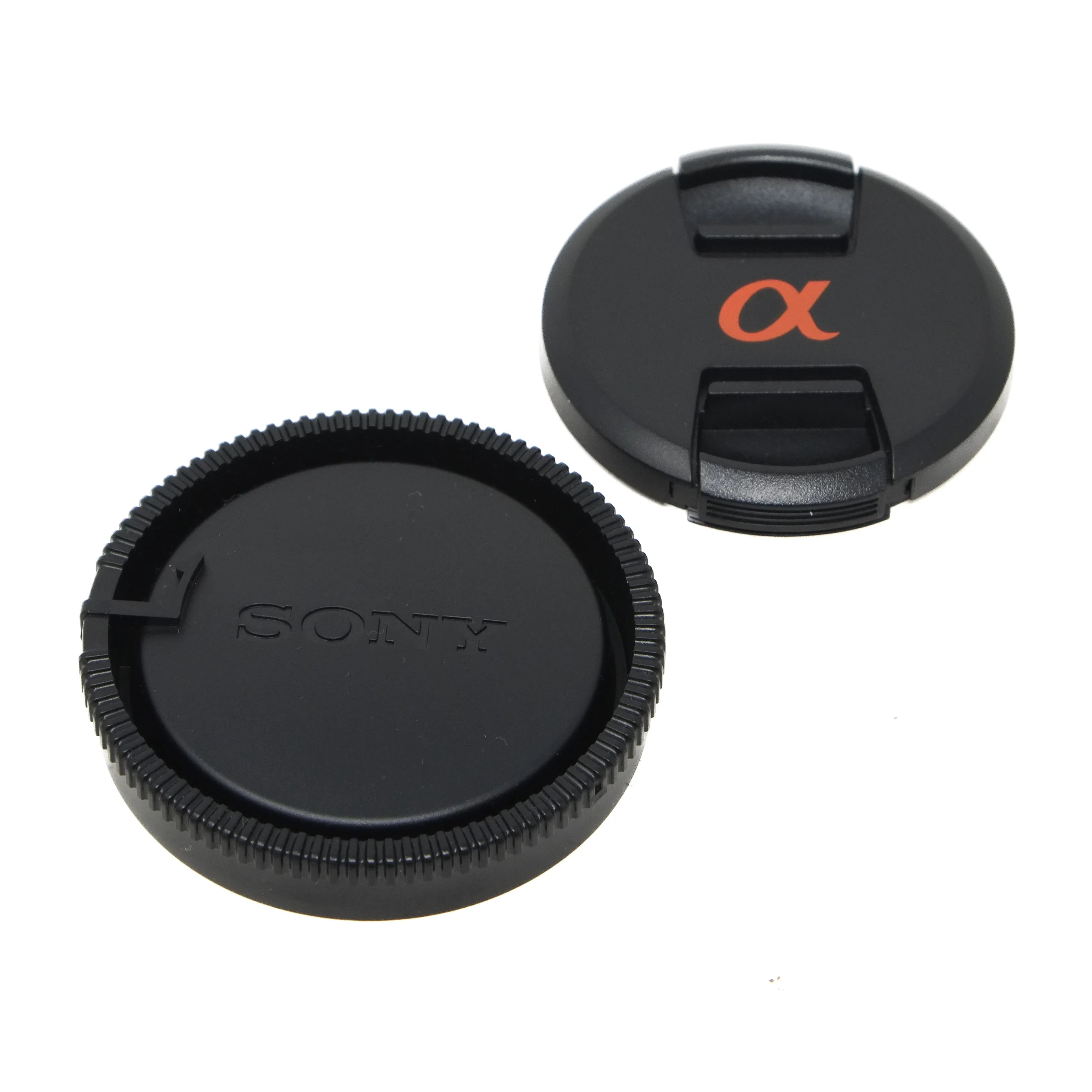 Sony and Alpha camera lens caps on a white background