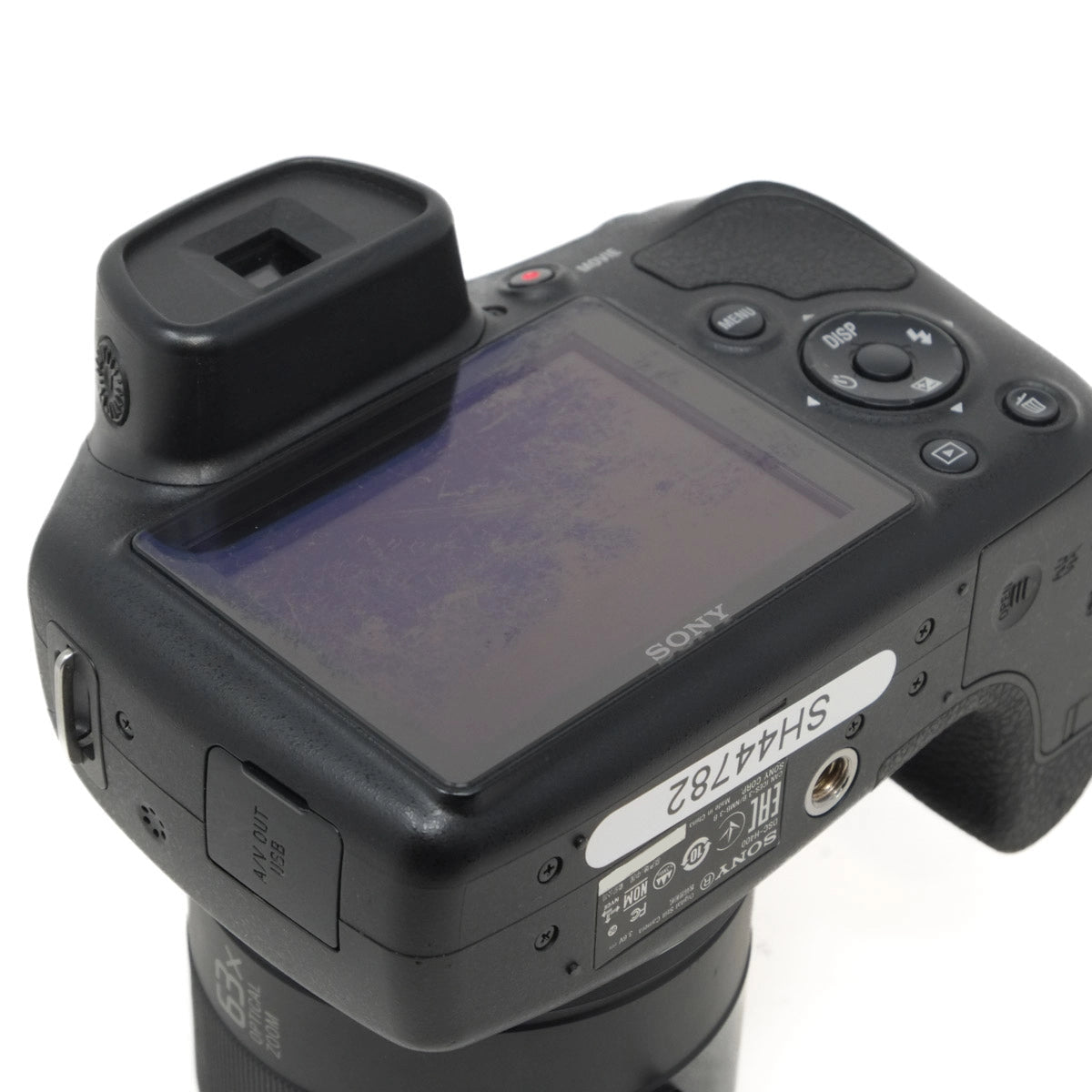 Back view of a Sony camera with screen and control buttons on a white background