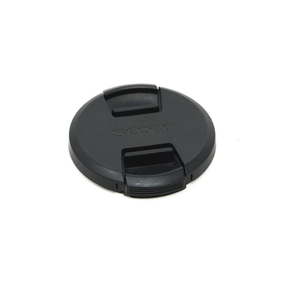 Black Sony lens cap on a white background