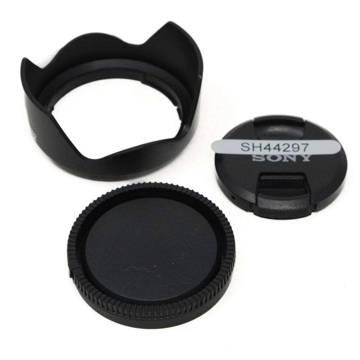 Set of camera lens caps and hood on a white background