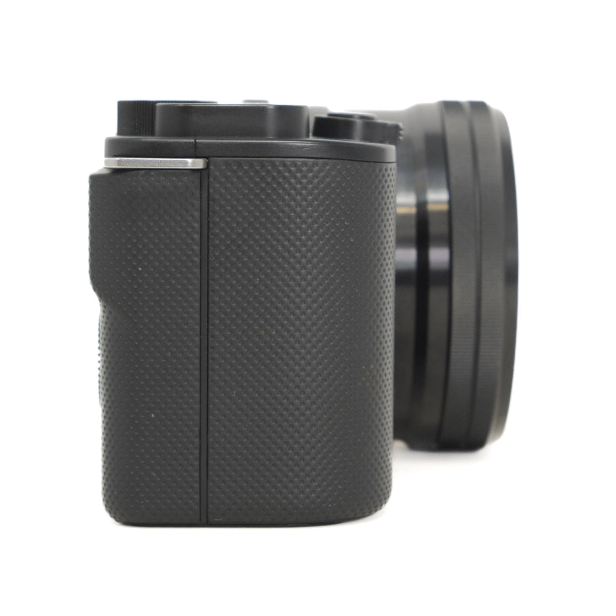 Black textured camera body with lens on a white background