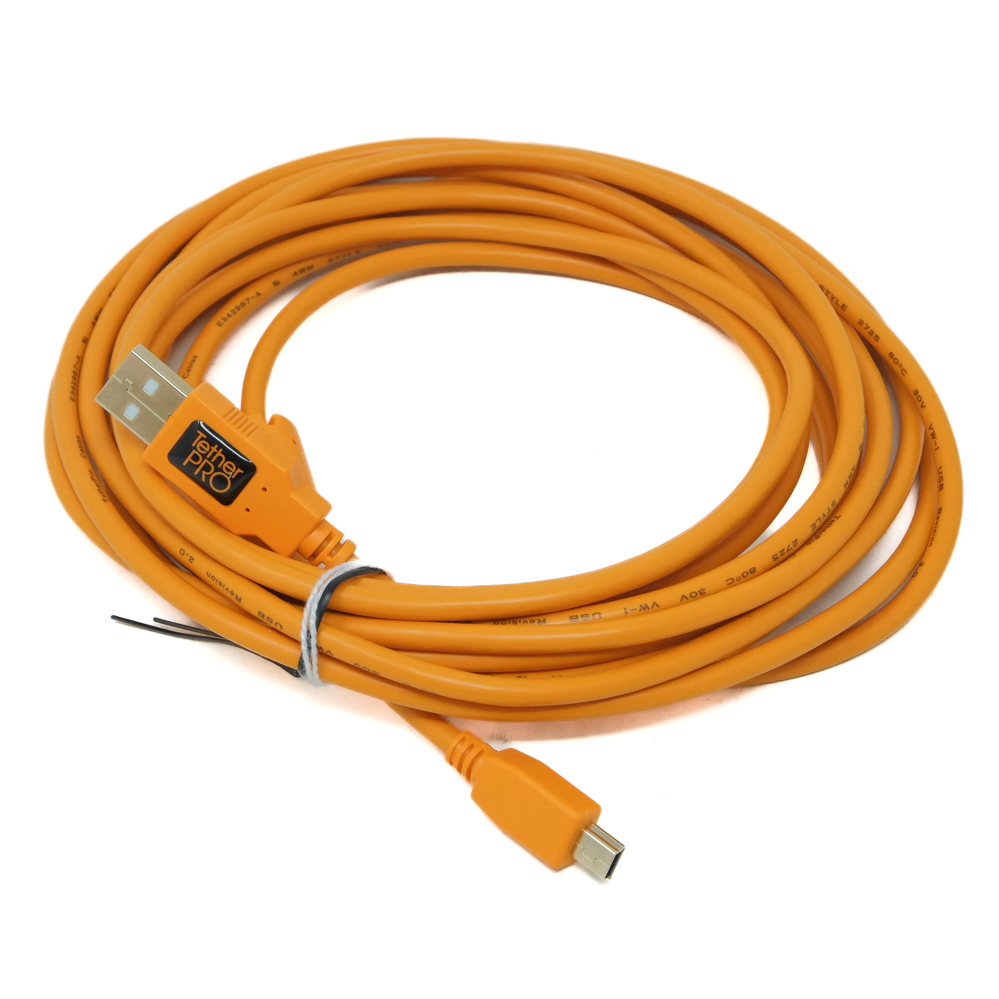 Coiled orange USB cable with connectors on a white background