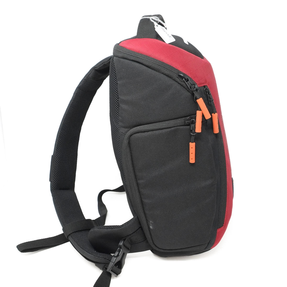 Red and black sling bag with orange zippers on a white background