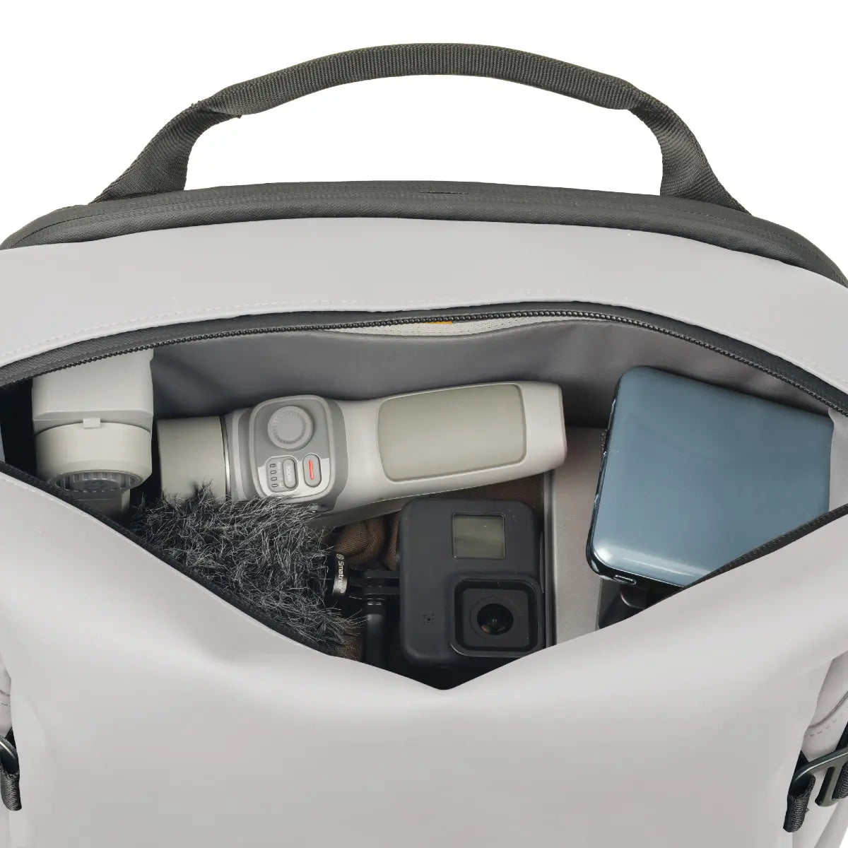 Backpack with camera equipment inside on a white background