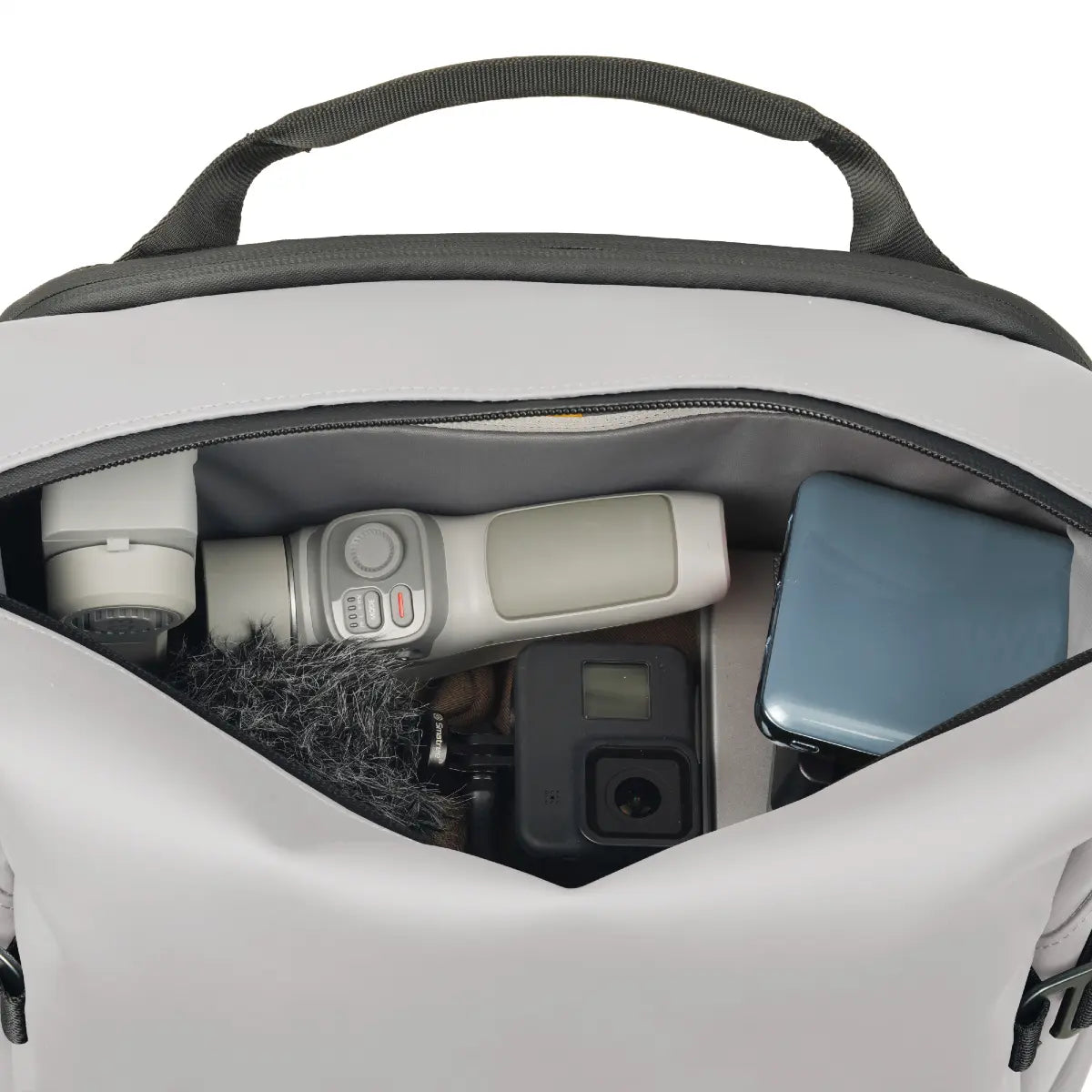 Backpack with camera equipment inside on a white background