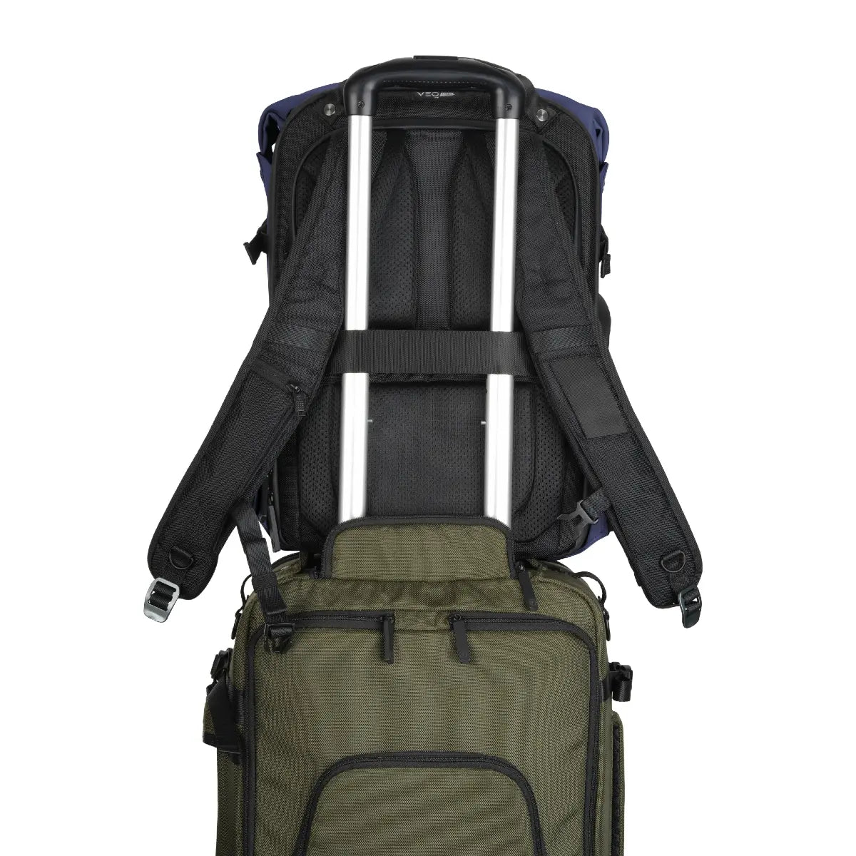 Green suitcase with a black backpack on top, on a white background