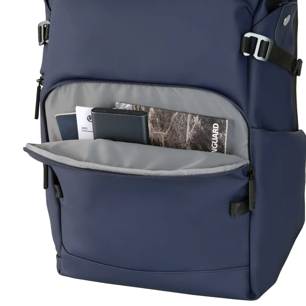 Navy blue backpack with open front pocket showing items inside on a white background