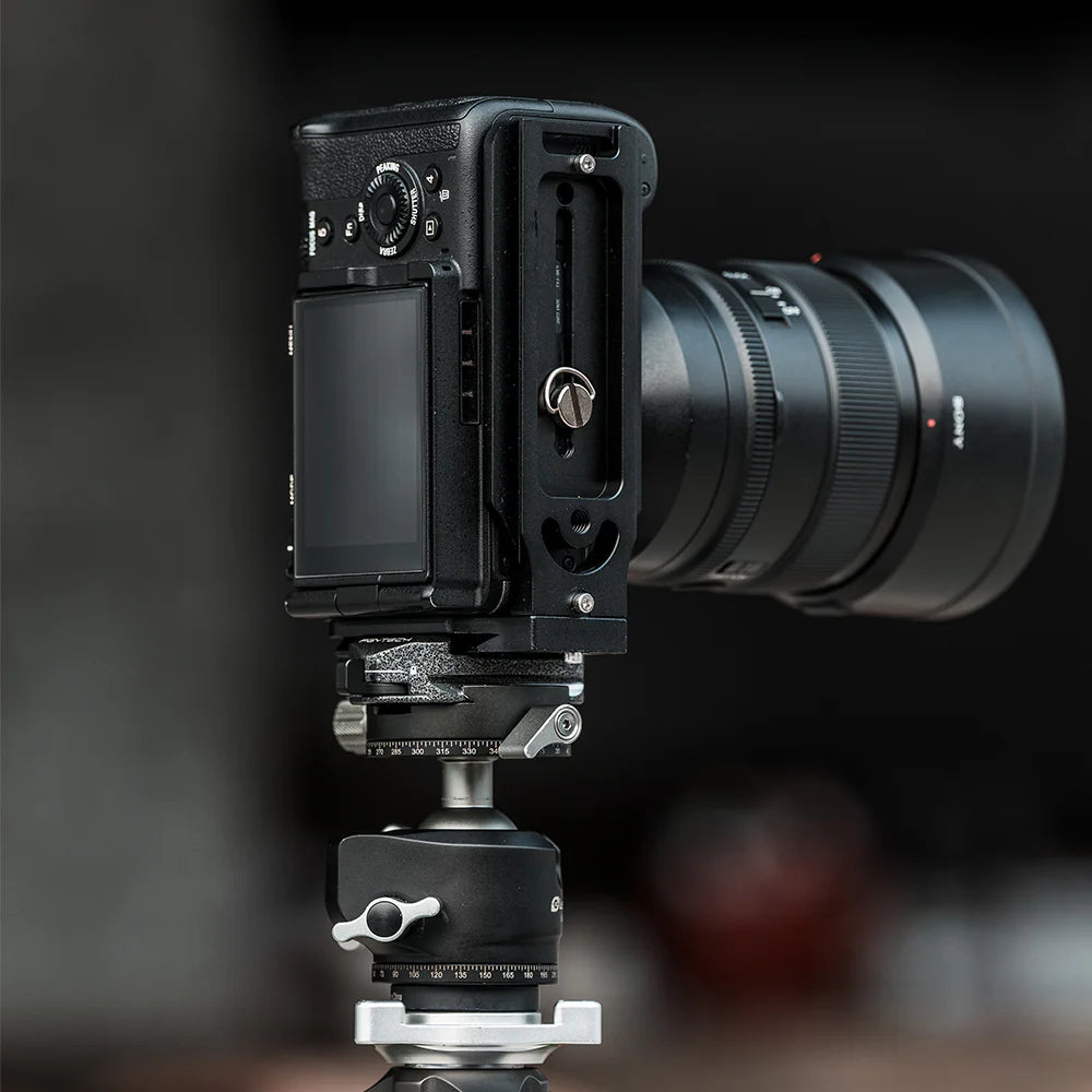 Camera with lens and attached accessories on a dark background