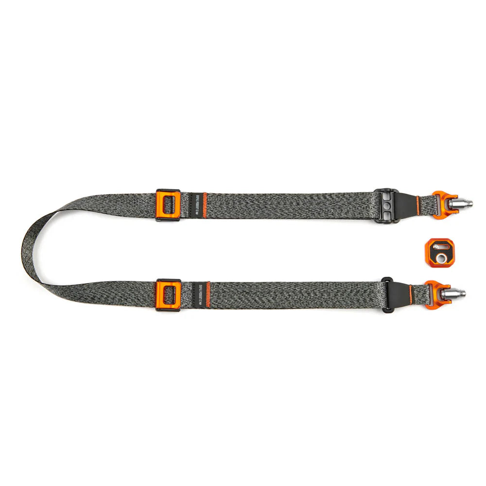 Gray and orange camera strap with quick-release buckle on a white background