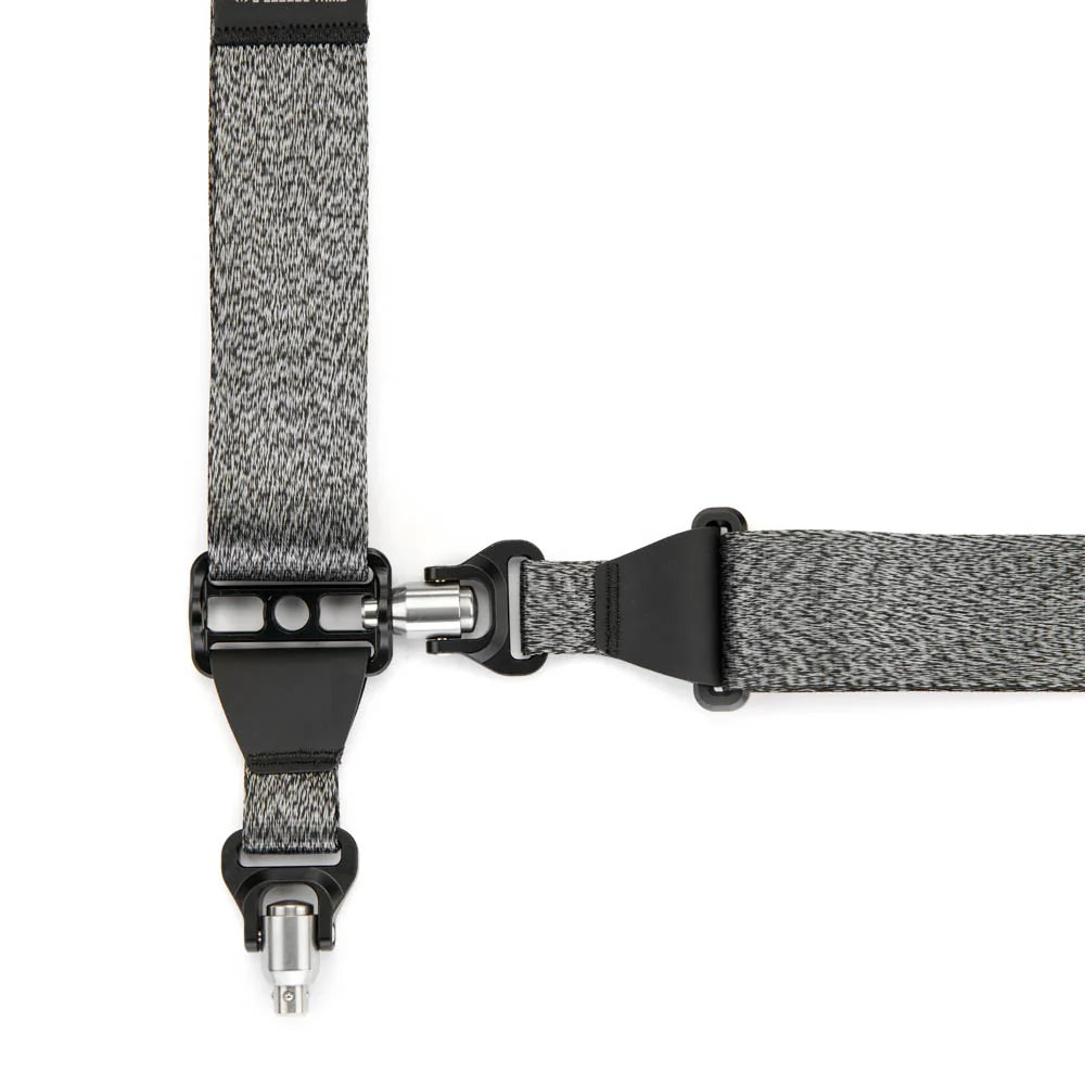 Close-up of a gray and black strap with a metal clip on a white background