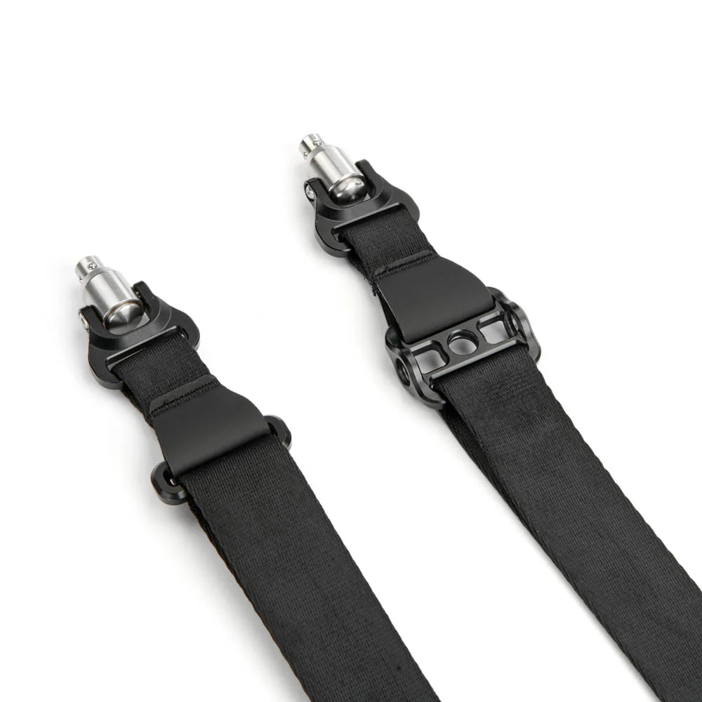Black camera strap with silver clips on a white background
